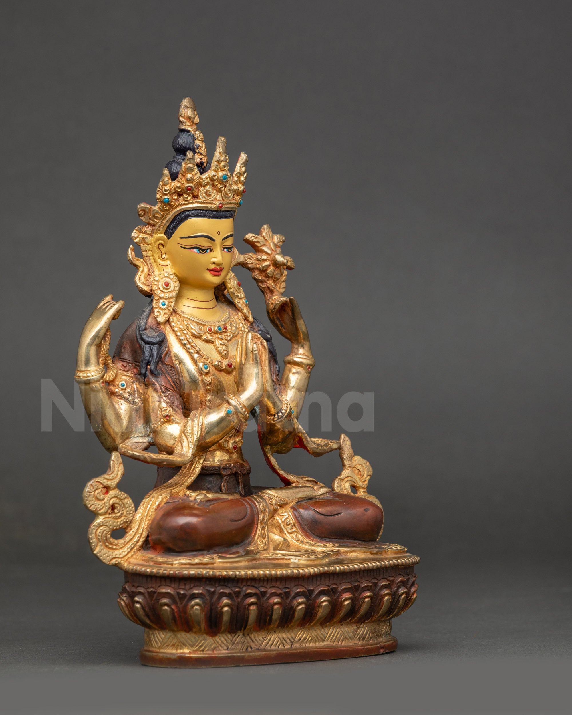 Side view of Chenrezig statue showing lotus seat crystal rosary and blooming lotus