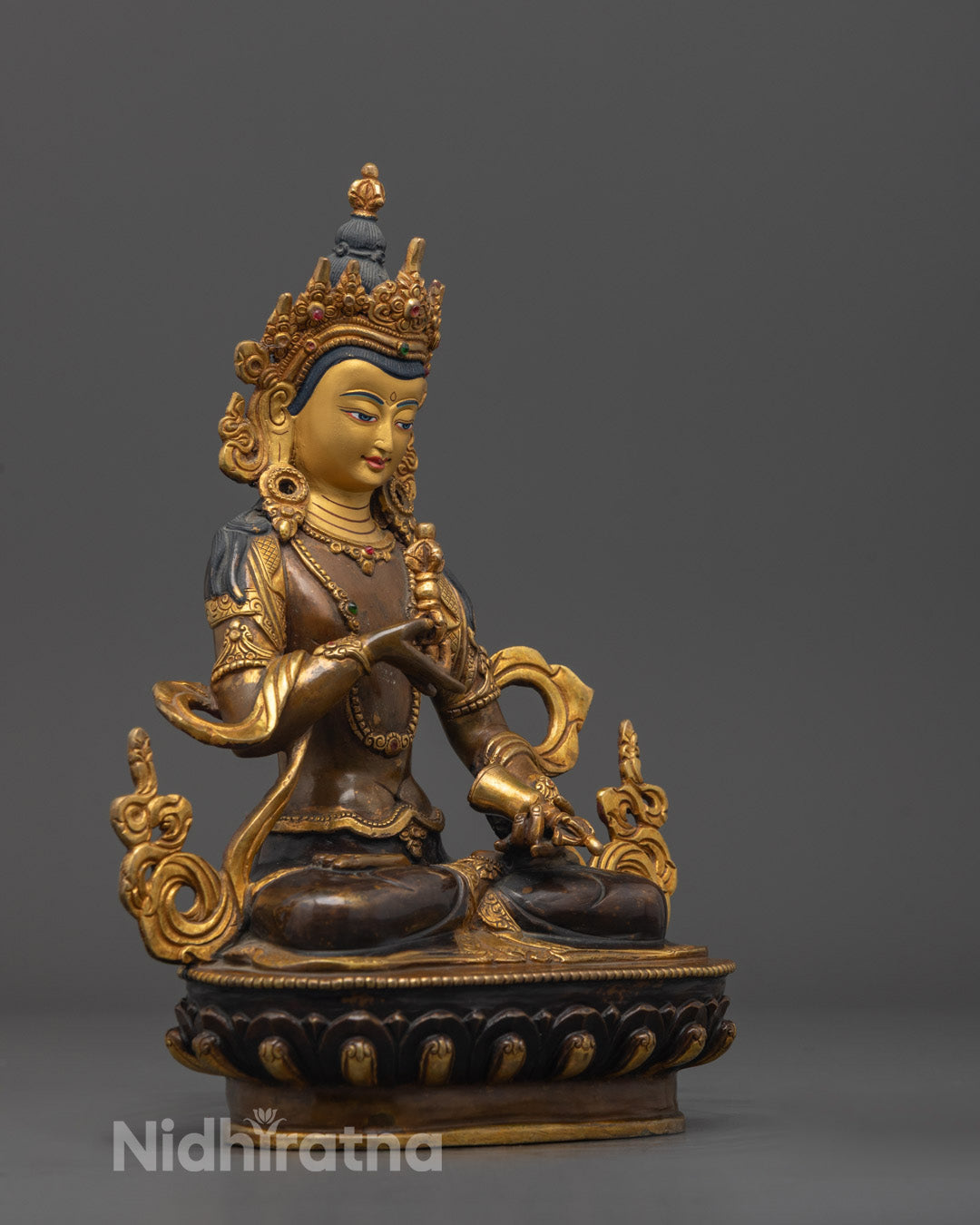 Side view of Dorje Sempa statue seated on lotus base, showcasing traditional Tibetan