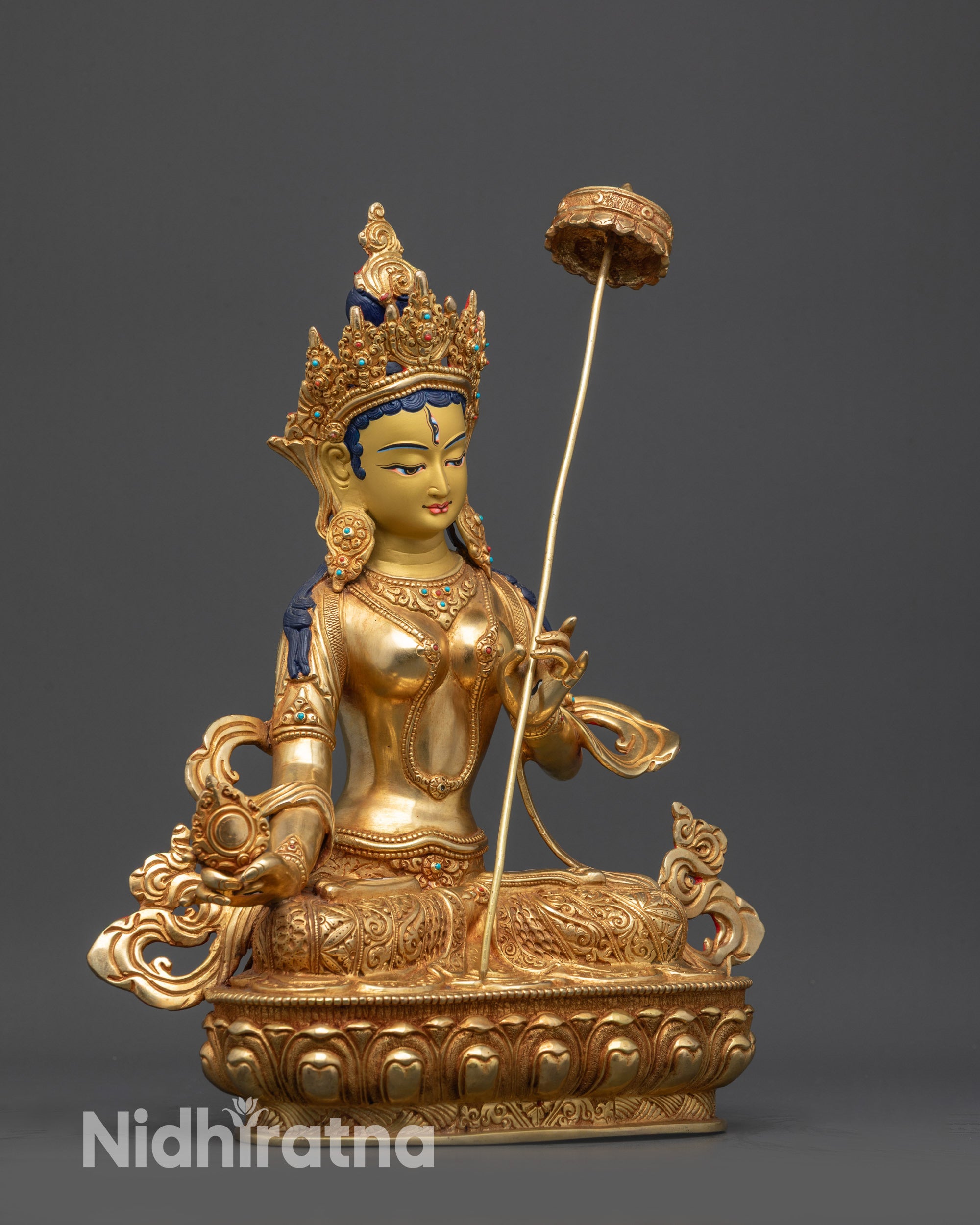Side view of Dukar Bodhisattva statue with flowing robe, crown, and wisdom wheel