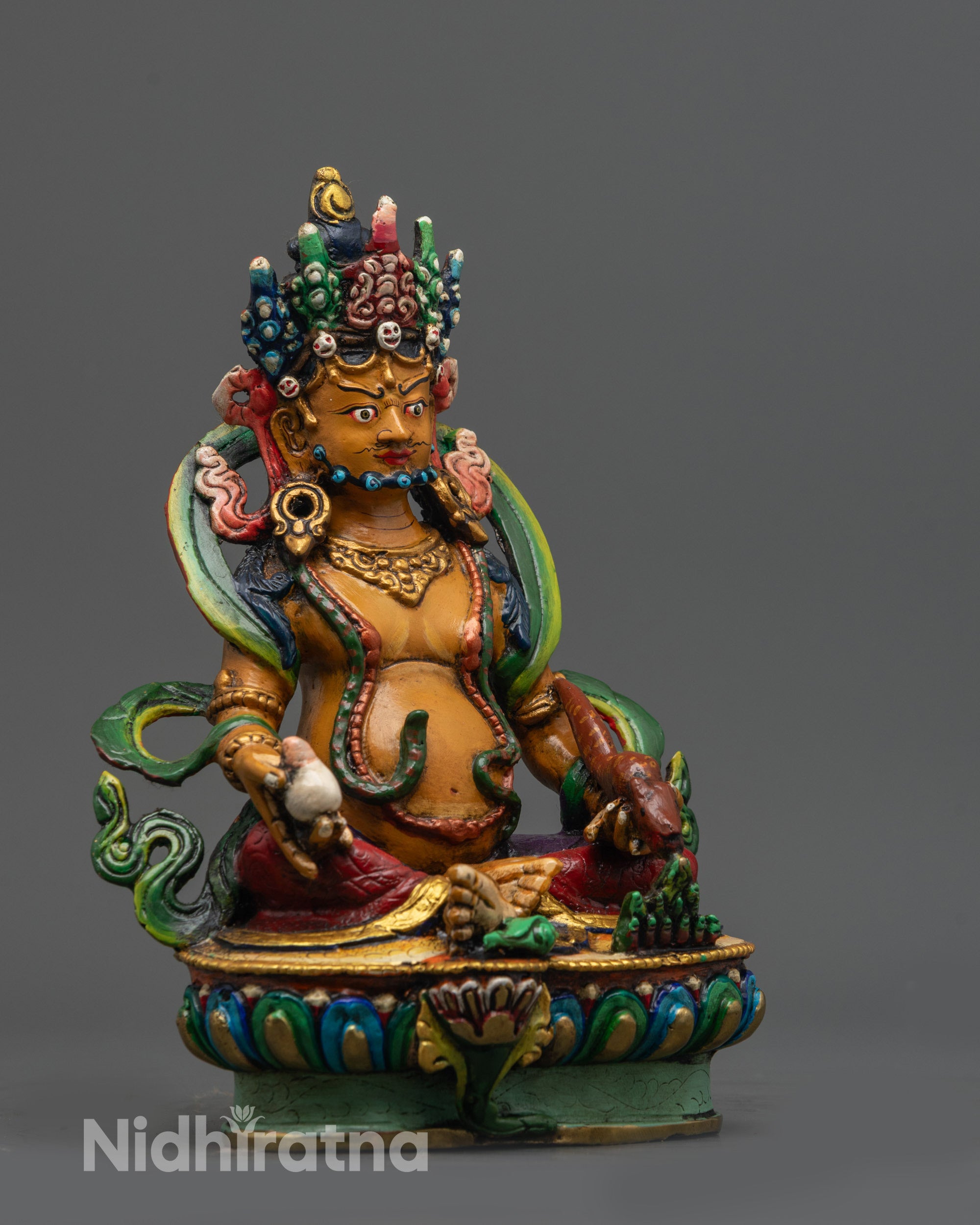 Side view of Dzambhala Statue with swirling robe holding citron fruits and mongoose