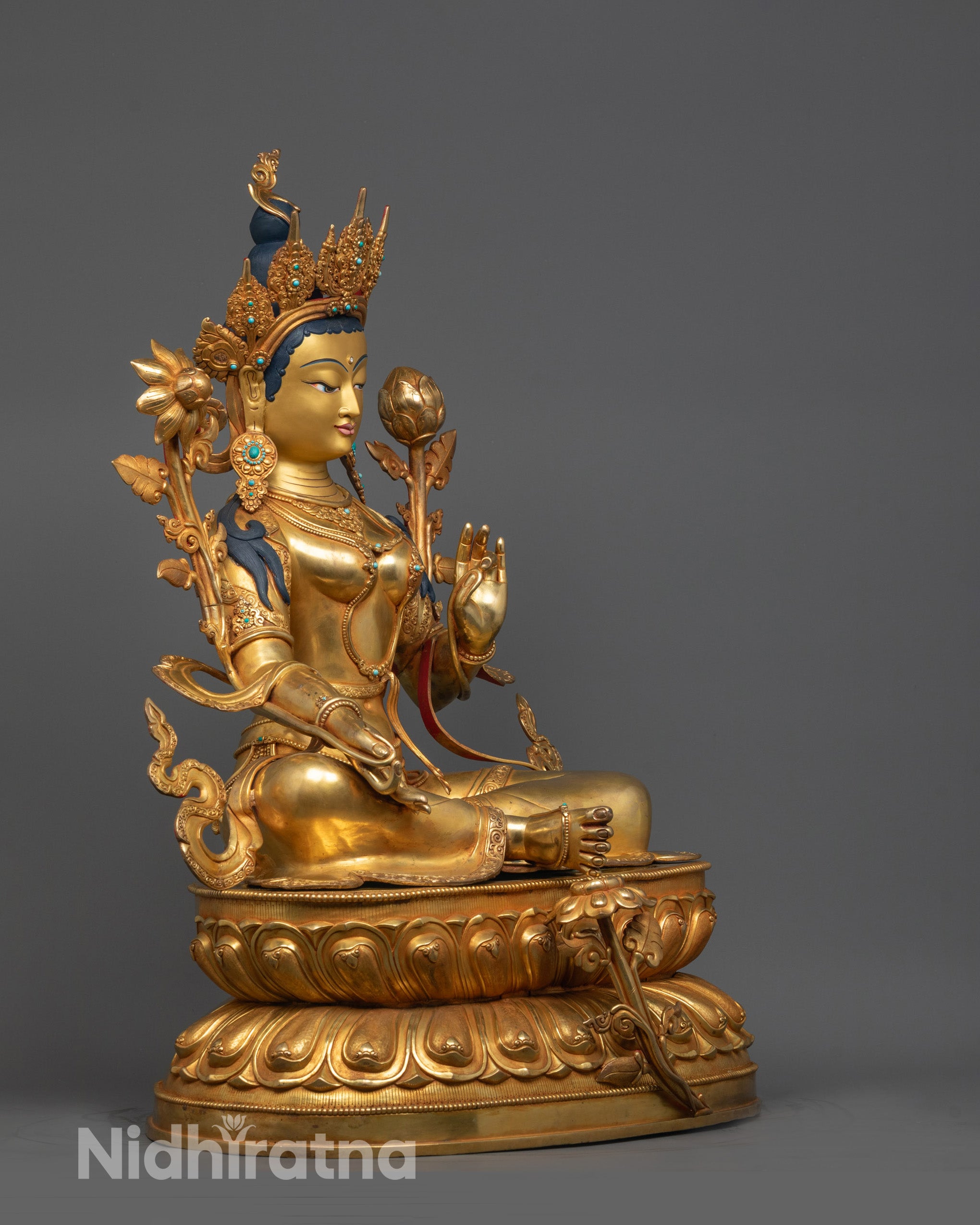 Side view of Green Tara Sculpture showing intricate lotus base and traditional Himalayan