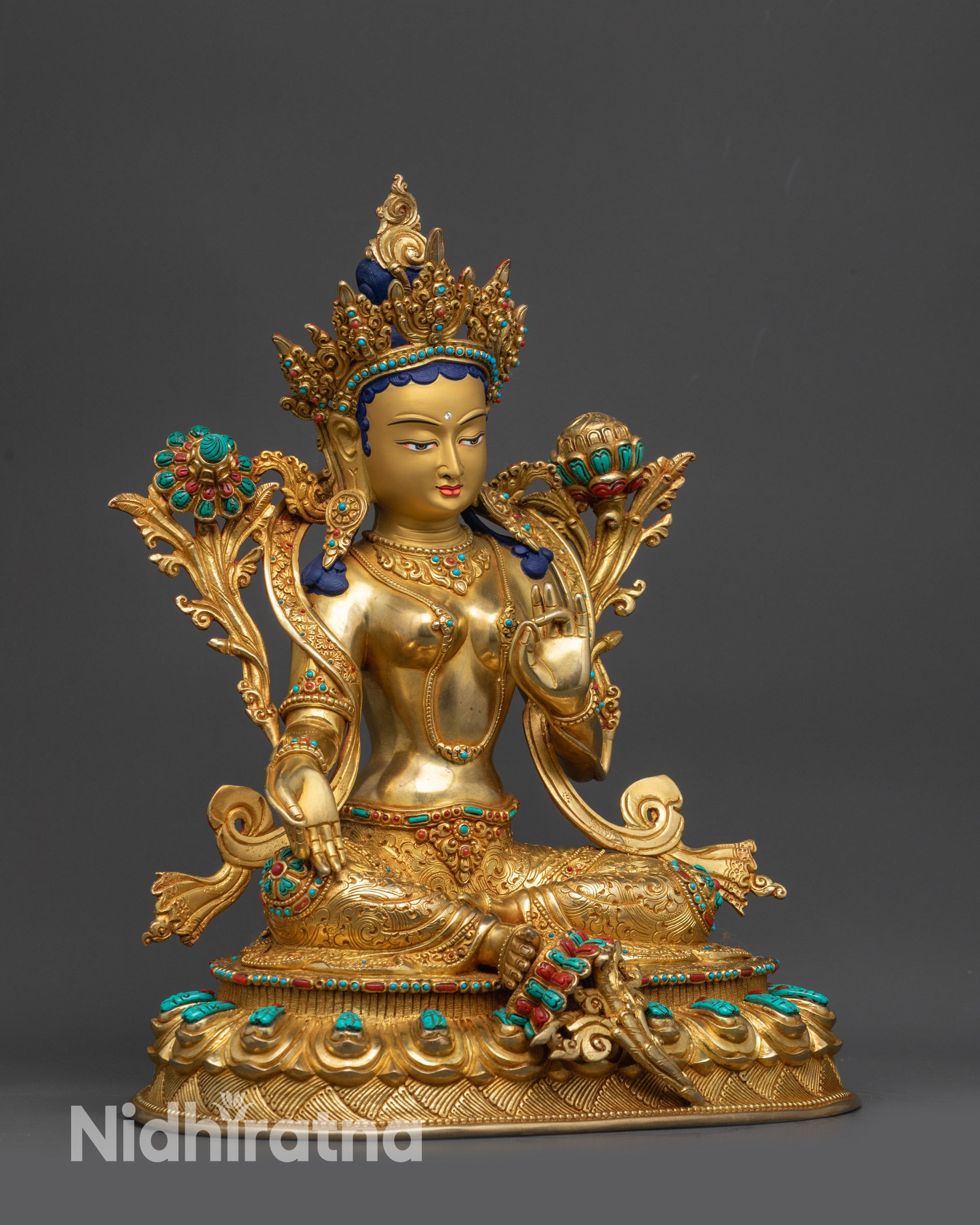 Side view of Green Tara sculpture showing floating robe and Utpala flower