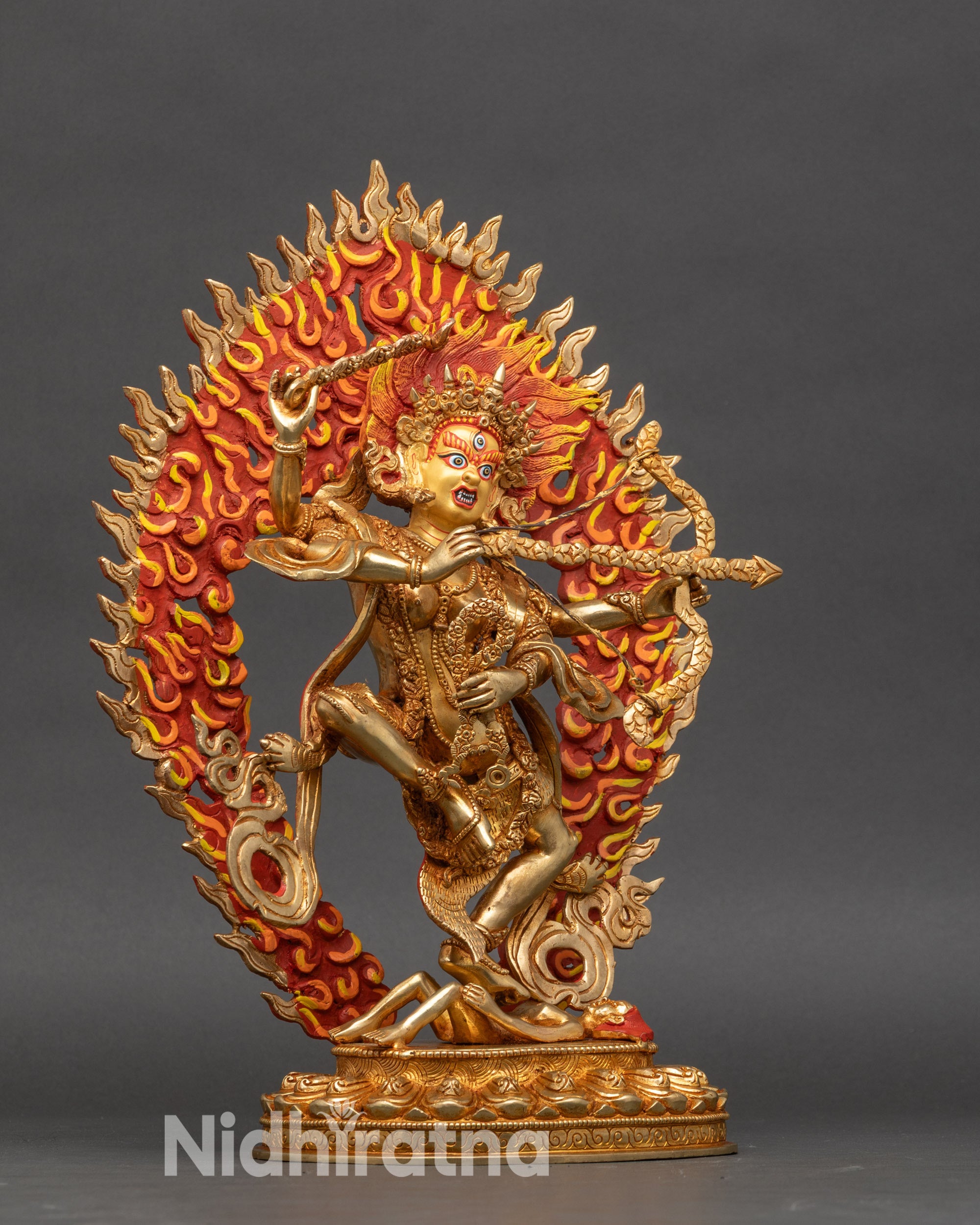 Side view of Kurukulla sculpture with gold fire-gilded finish and dynamic pose