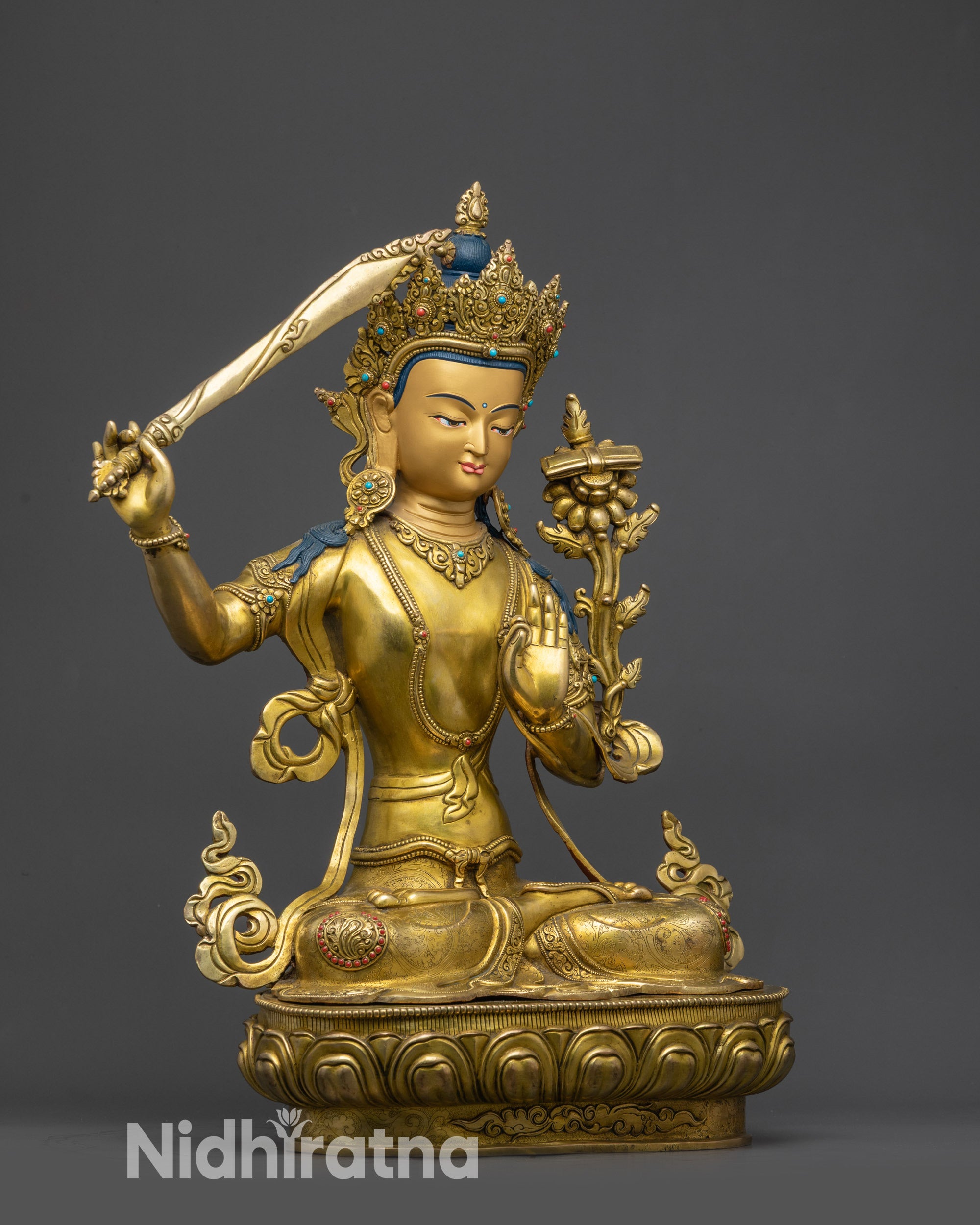 Side view of Manjushri Bodhisattva holding flaming sword and utpala flower