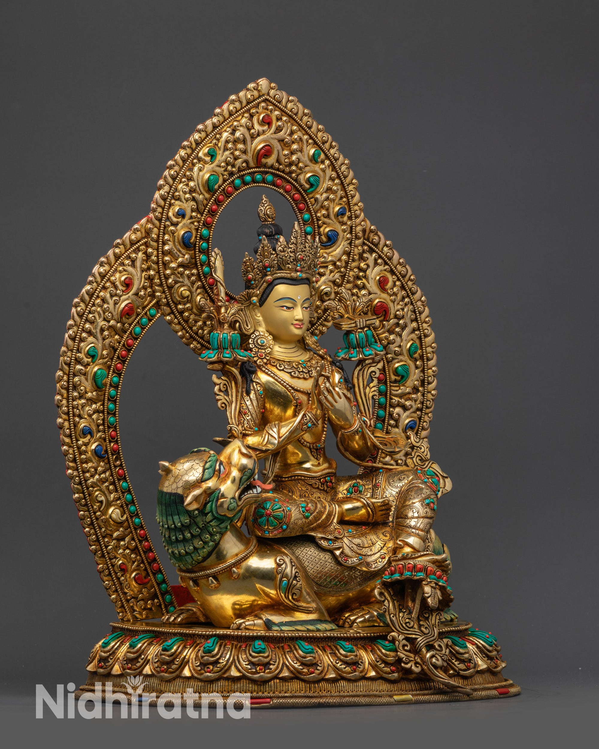 Side view of Manjushri statue highlighting dharmachakra mudra and utpala flower