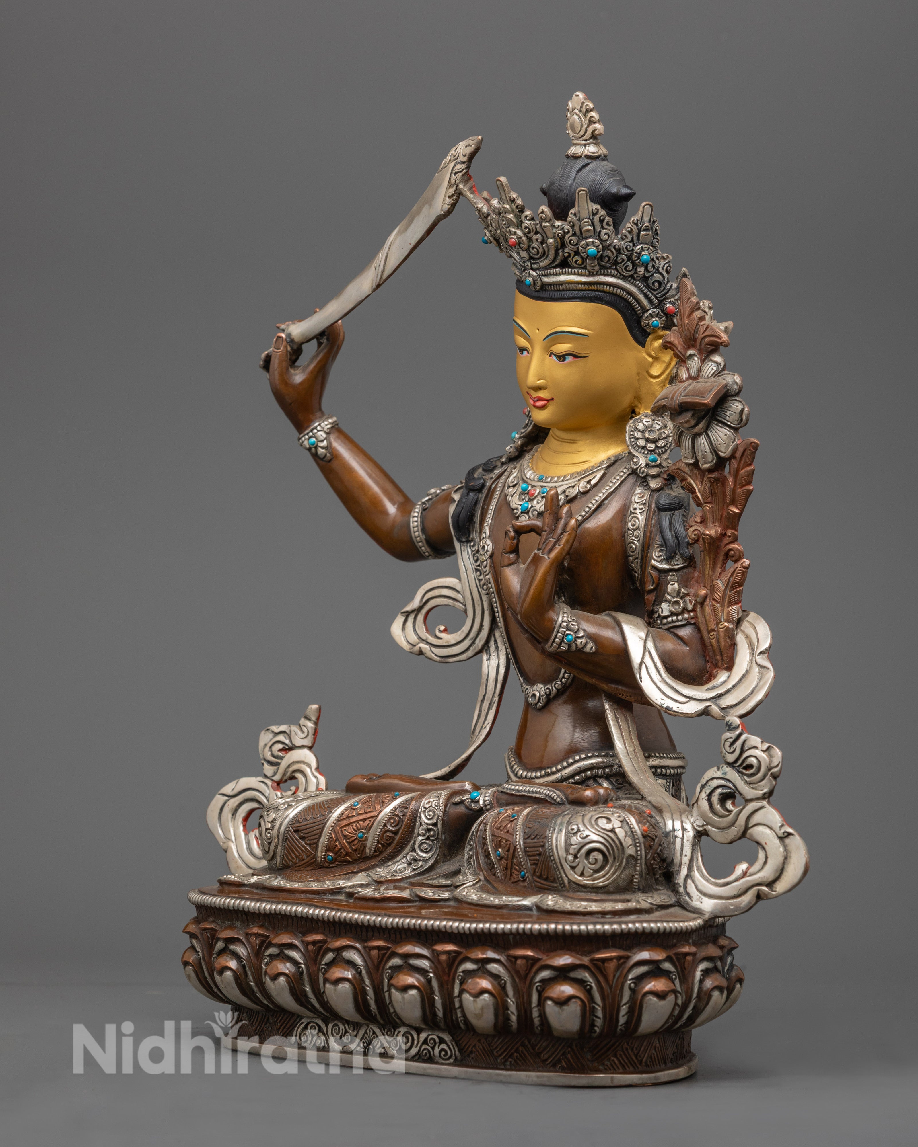 Manjushri statue showing ornate robe details and vibrant acrylic colors