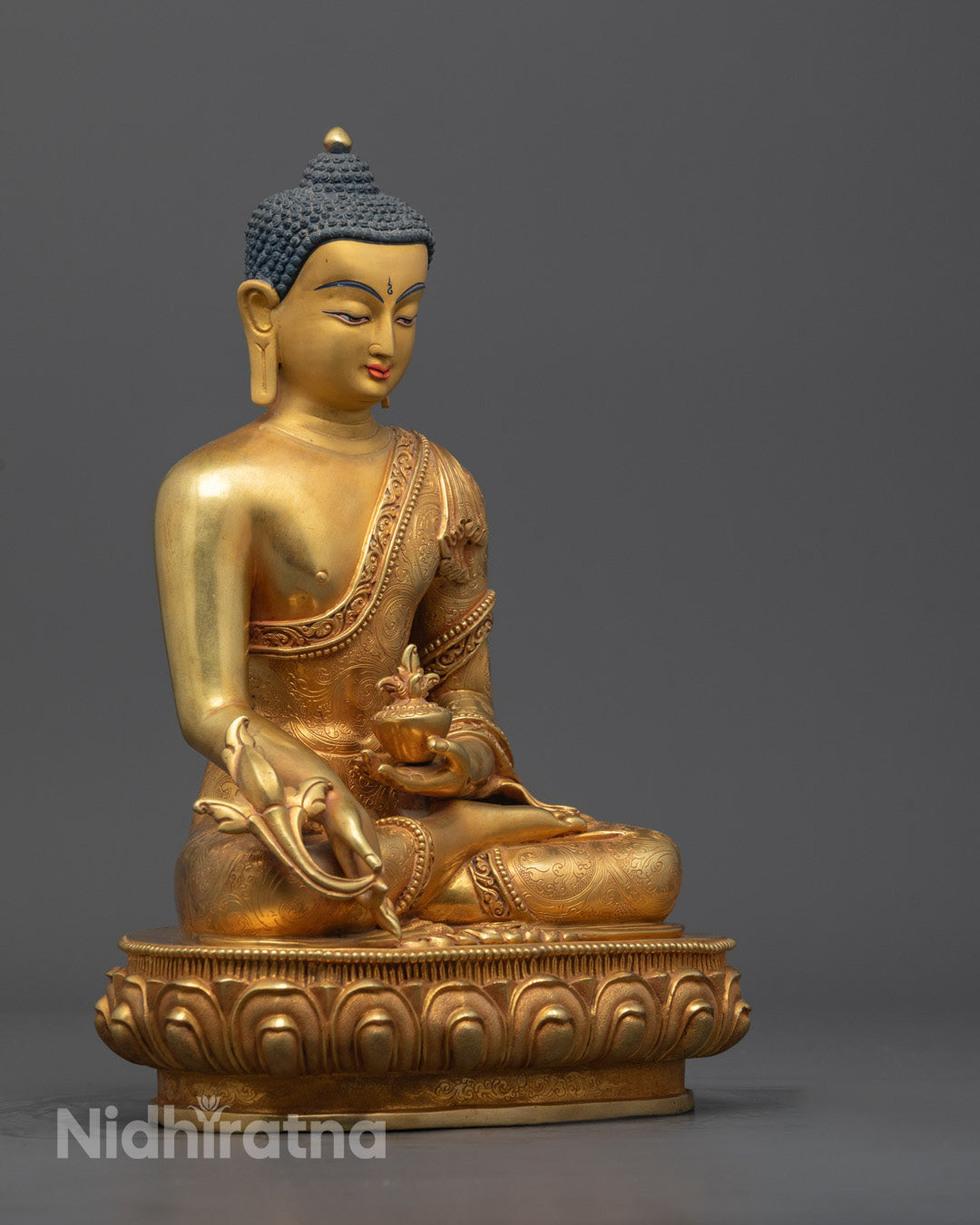 Side view of Medicine Buddha statue highlighting copper base and traditional lost wax craft