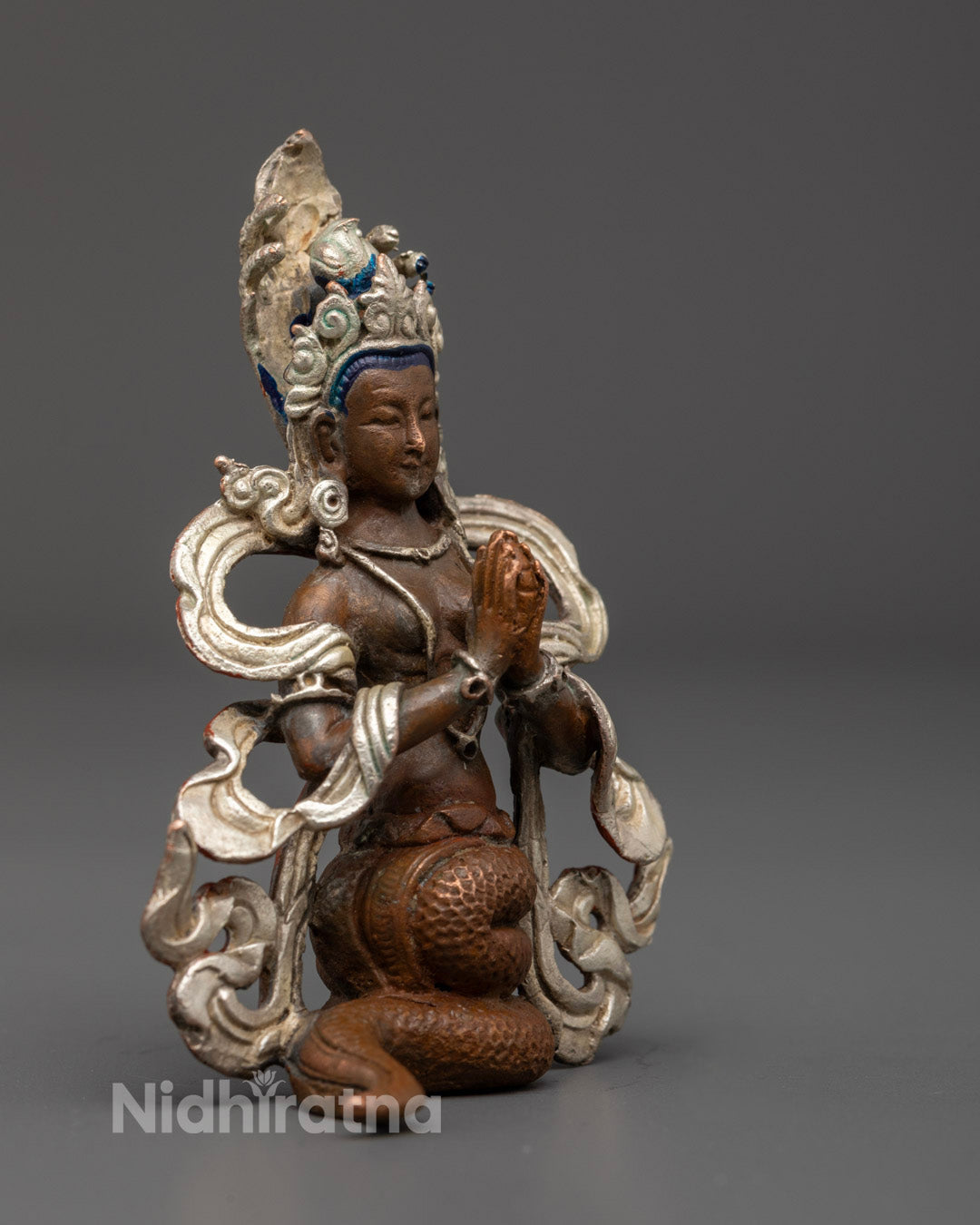 Nagakanya Statue displaying the elegant serpent tail and coiled base, emphasizing the connection to Naga energy and fertility in Buddhist tradition.