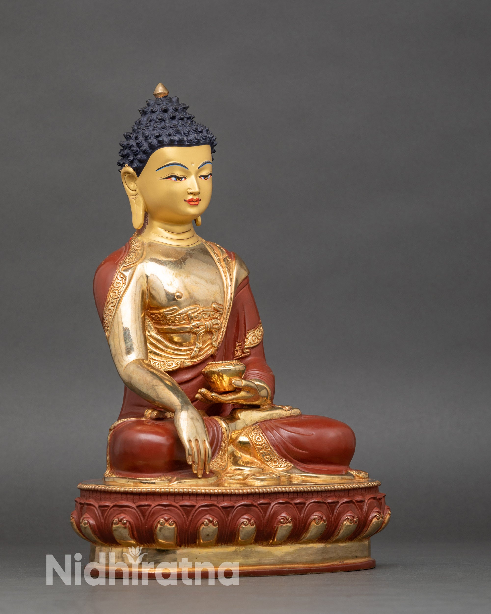 Side view of Nepalese Buddha statue, gold-painted details, symbolic mudras visible