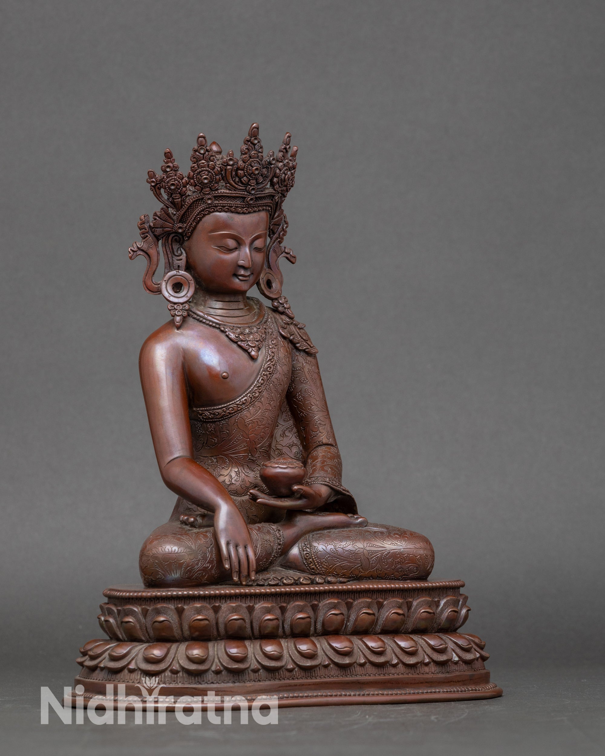 Side view of Nepalese Crown Buddha statue highlighting copper craftsmanship and oxidized finish