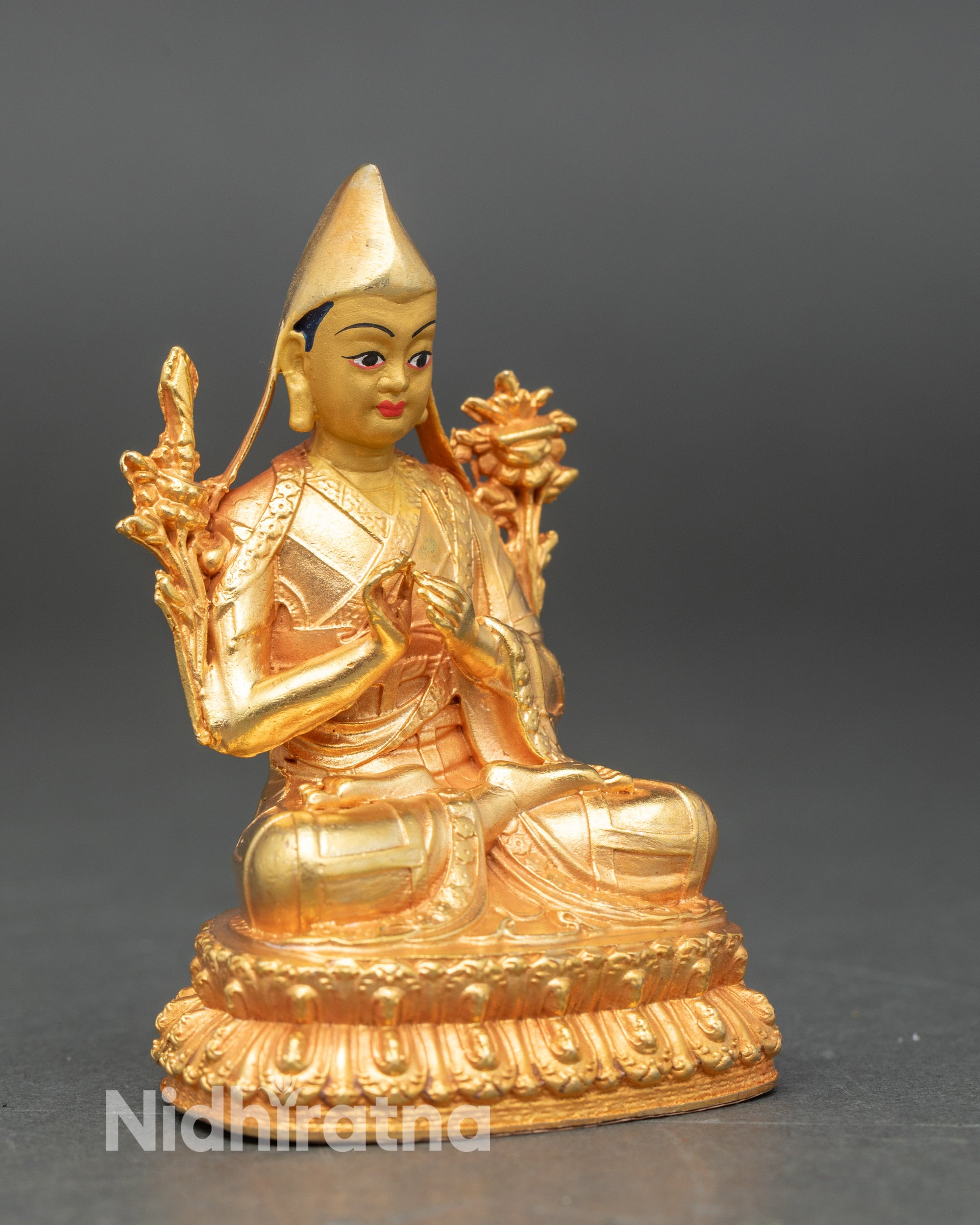 Side view of Nepalese Shakya Pandit statue highlighting gold fire-gilding and craftsmanship