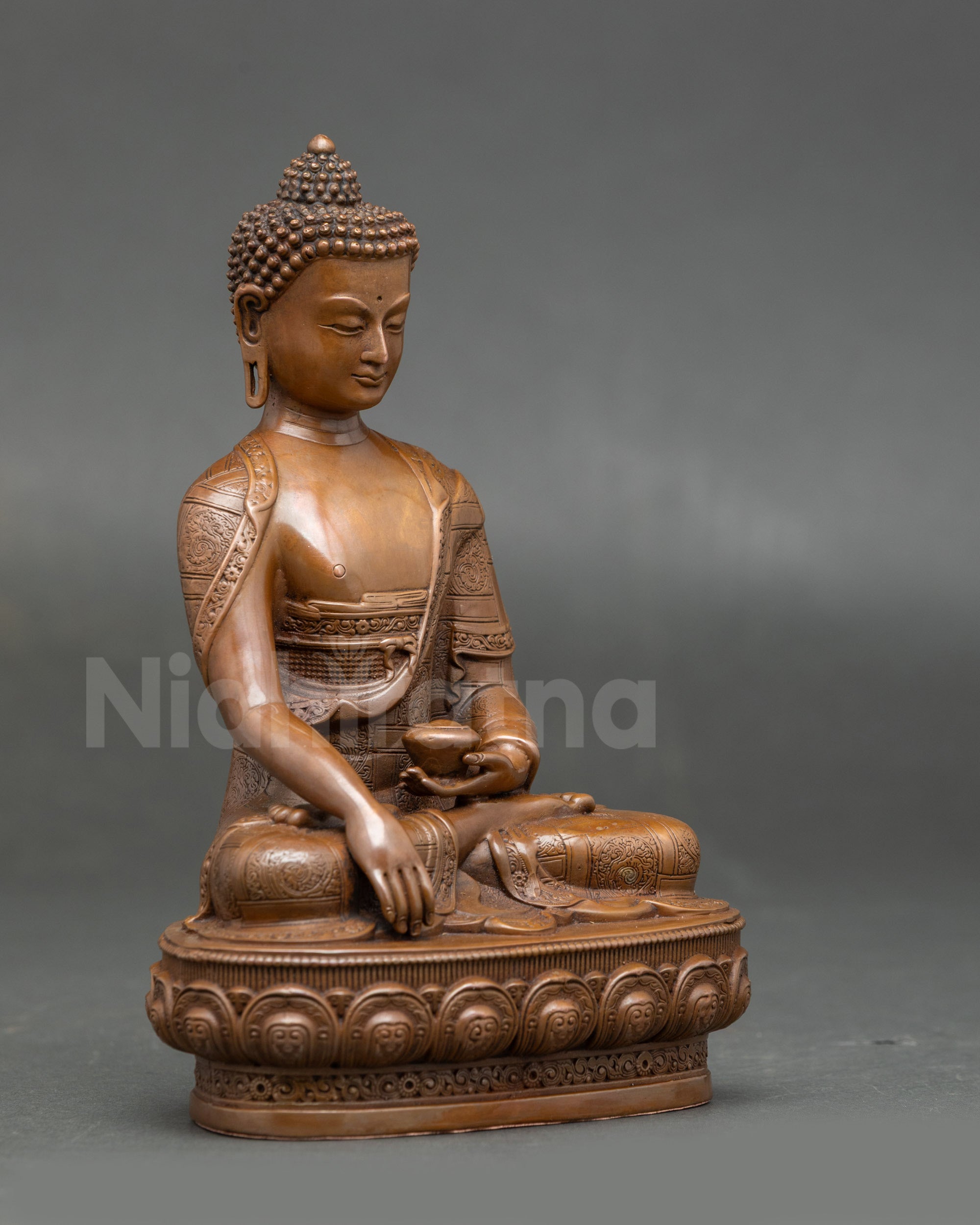 Side view of Nepalese Shakyamuni Buddha statue showing lotus seat and alms bowl, symbol of wisdom and mindfulness