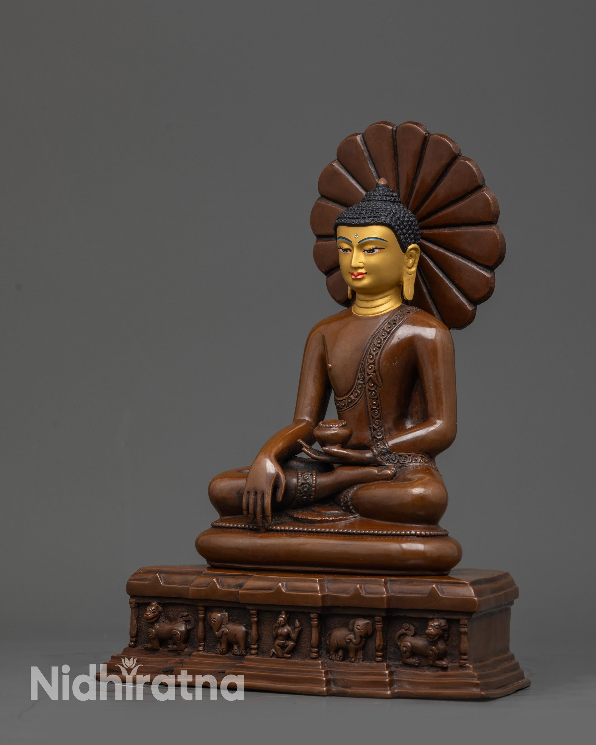 Side view of Nepalese handcrafted Shakyamuni Buddha in monk robe holding begging bowl
