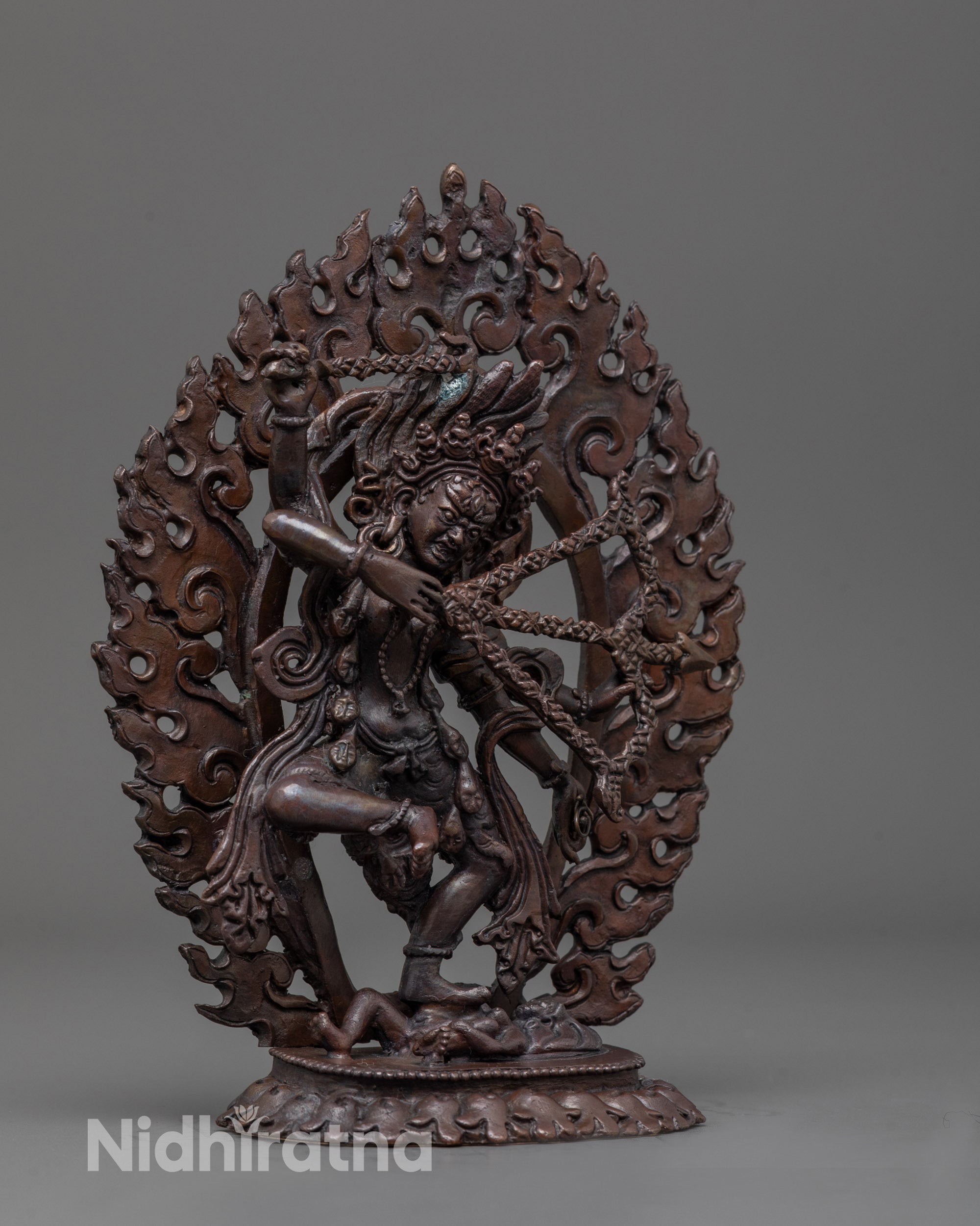Side view of Oxidized Kurukulla Statue showing flowing robes and wrathful posture