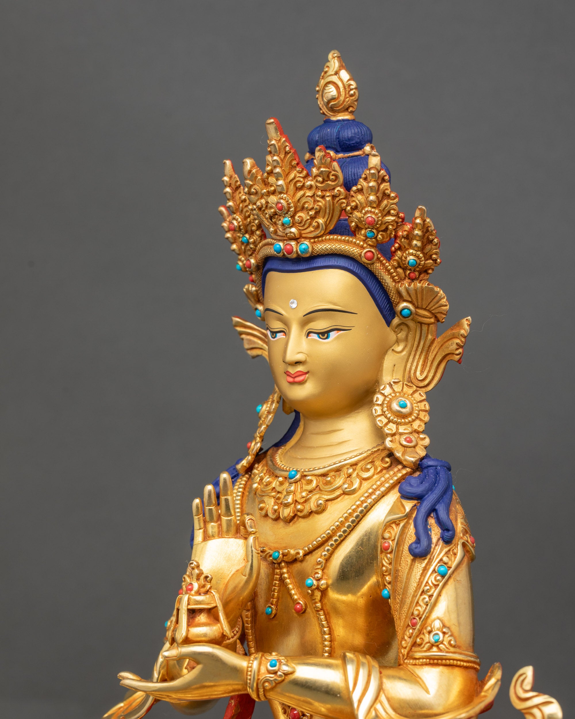 Side view of Samantabhadra statue showing intricate robe patterns and halo