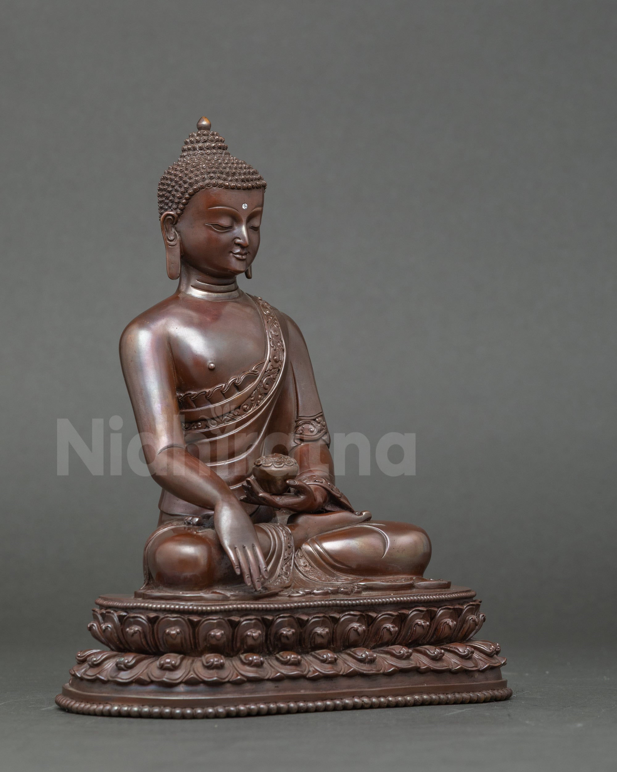 Side view of Shakyamuni Buddha on lotus throne, handmade copper meditation statue
