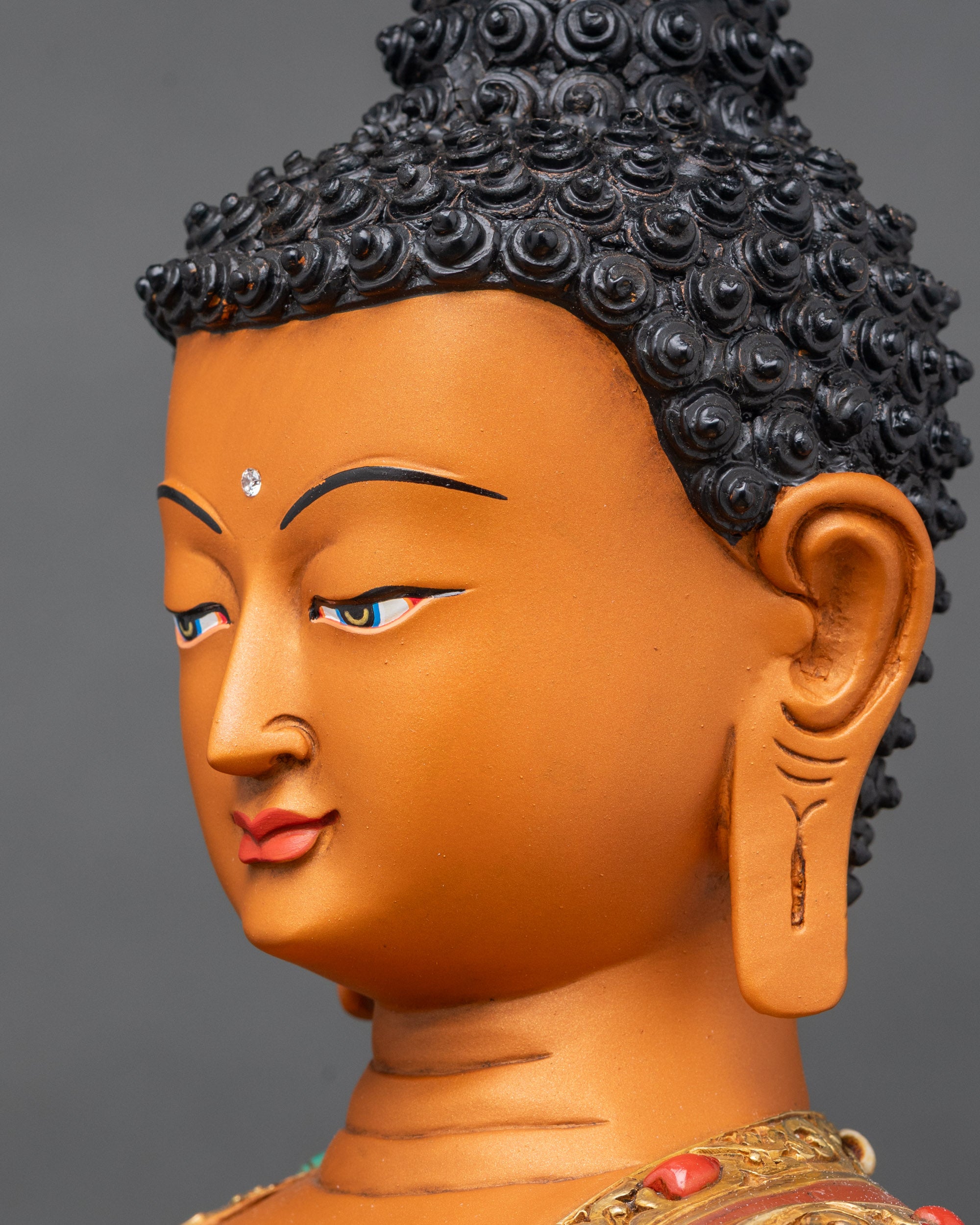 Side view of Shakyamuni Buddha showing intricate robes and halo details