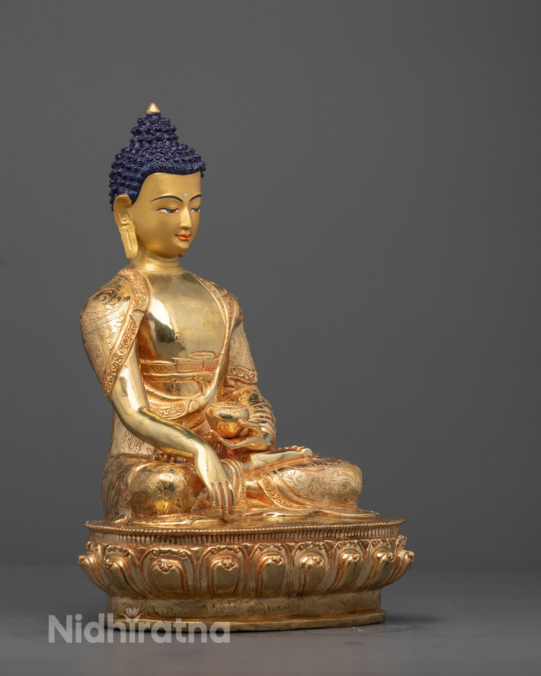 Side view of Shakyamuni Buddha statue holding monk’s bowl, crafted in copper