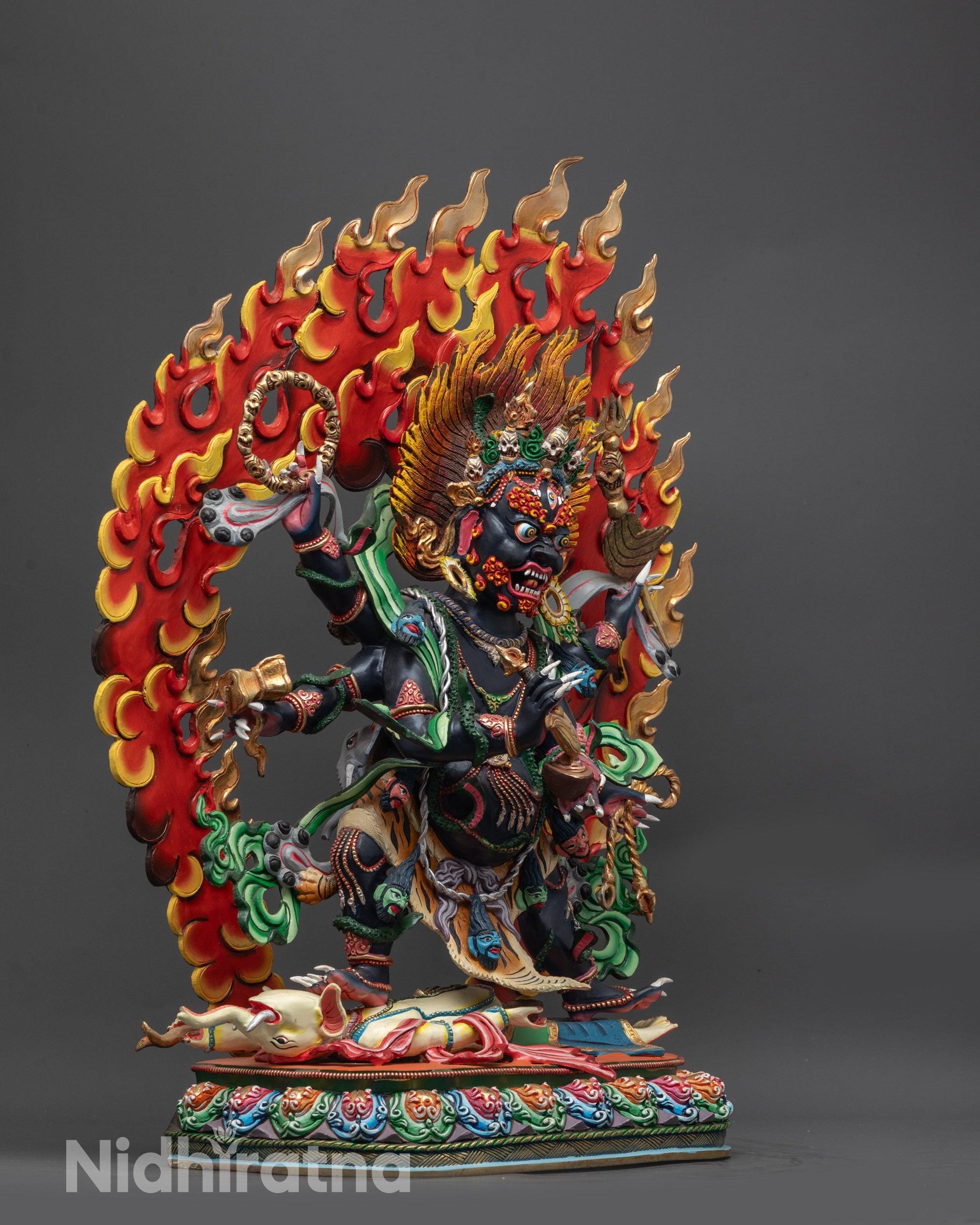 Side view of Six-Armed Mahakala Statue highlighting six arms and symbolic tools