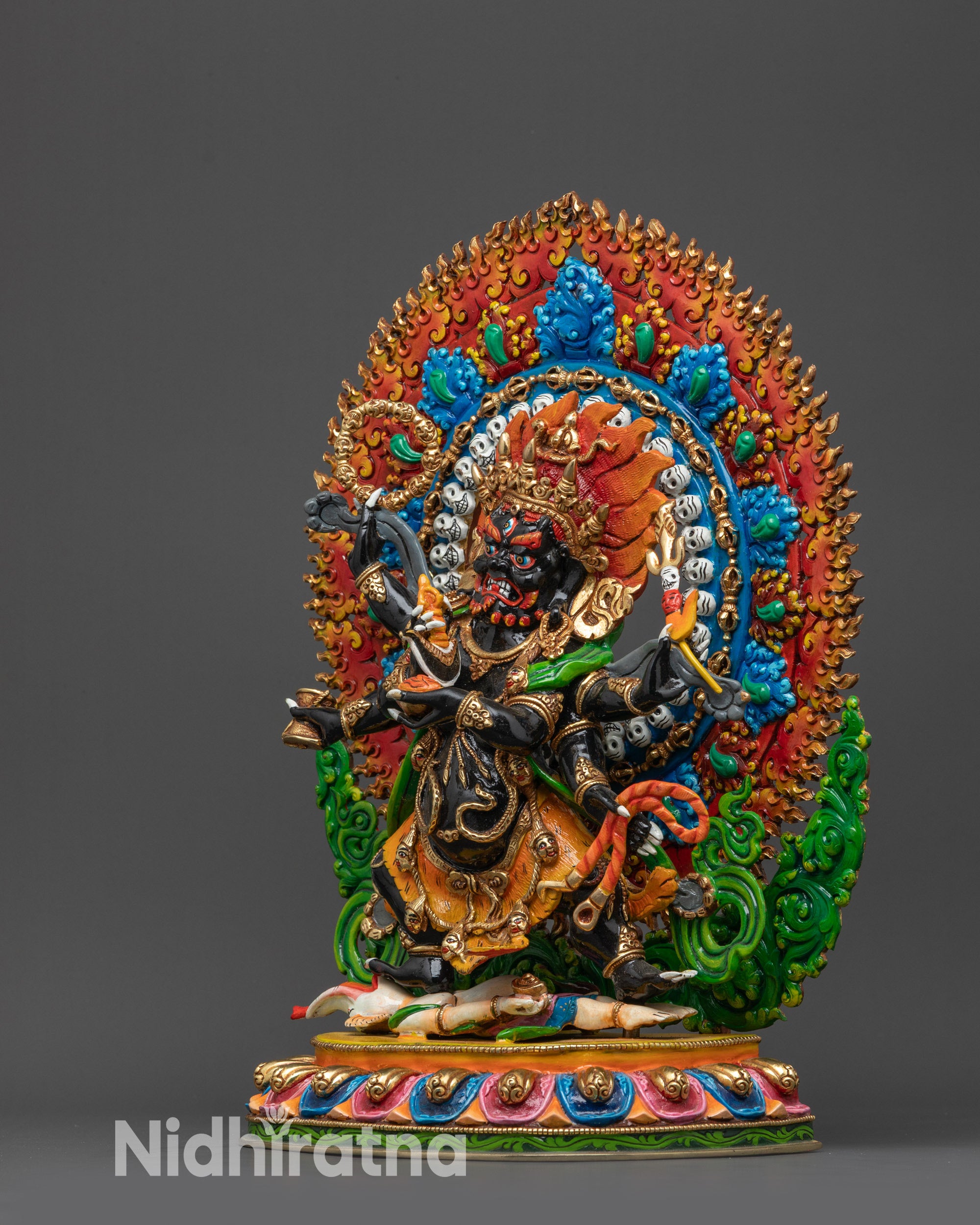 Side view of Six-Armed Mahakala holding sacred objects atop lotus seat with tiger-skin garment