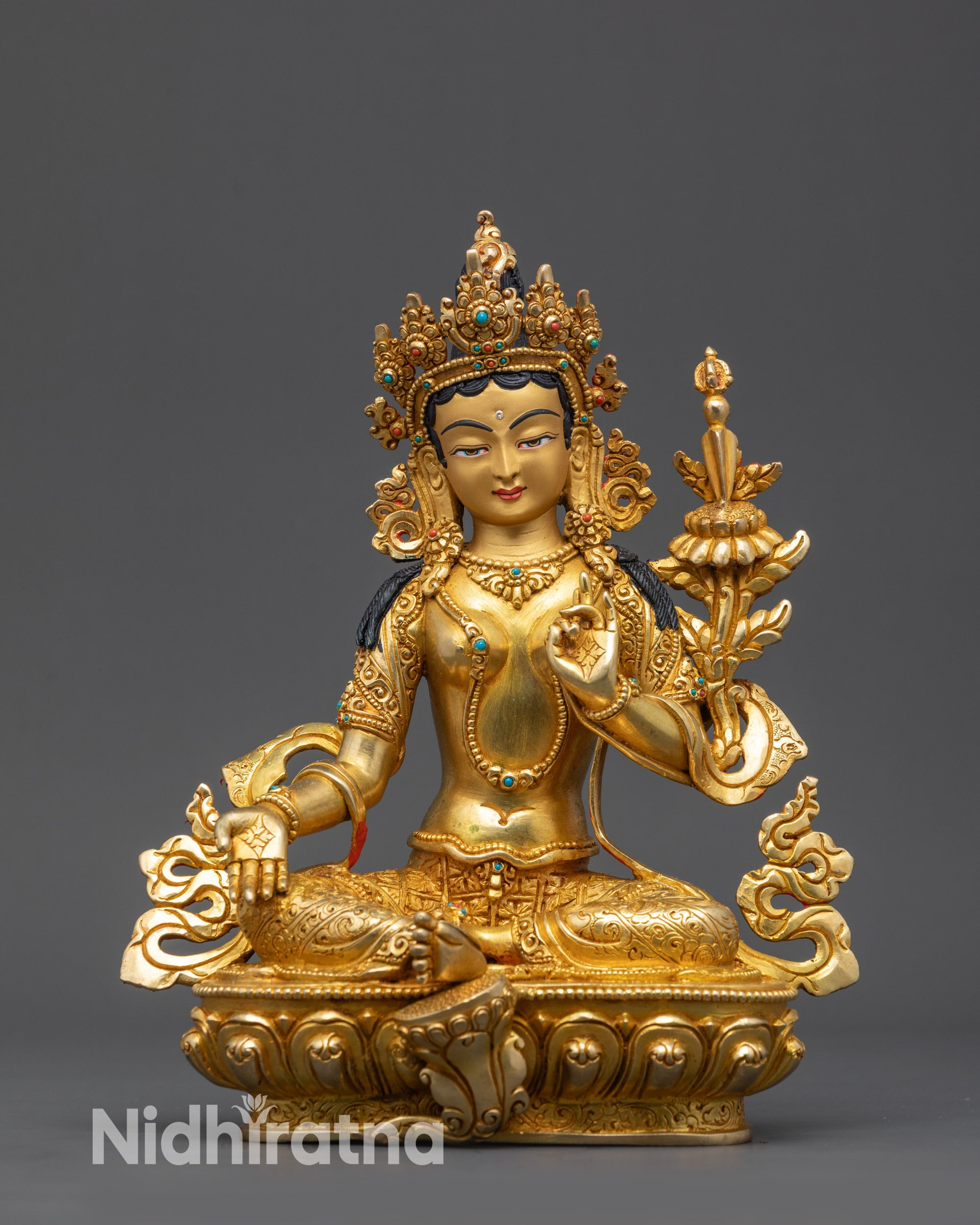 Side view of Tara sculptures showing varied mudras and flowing gold-gilded robes