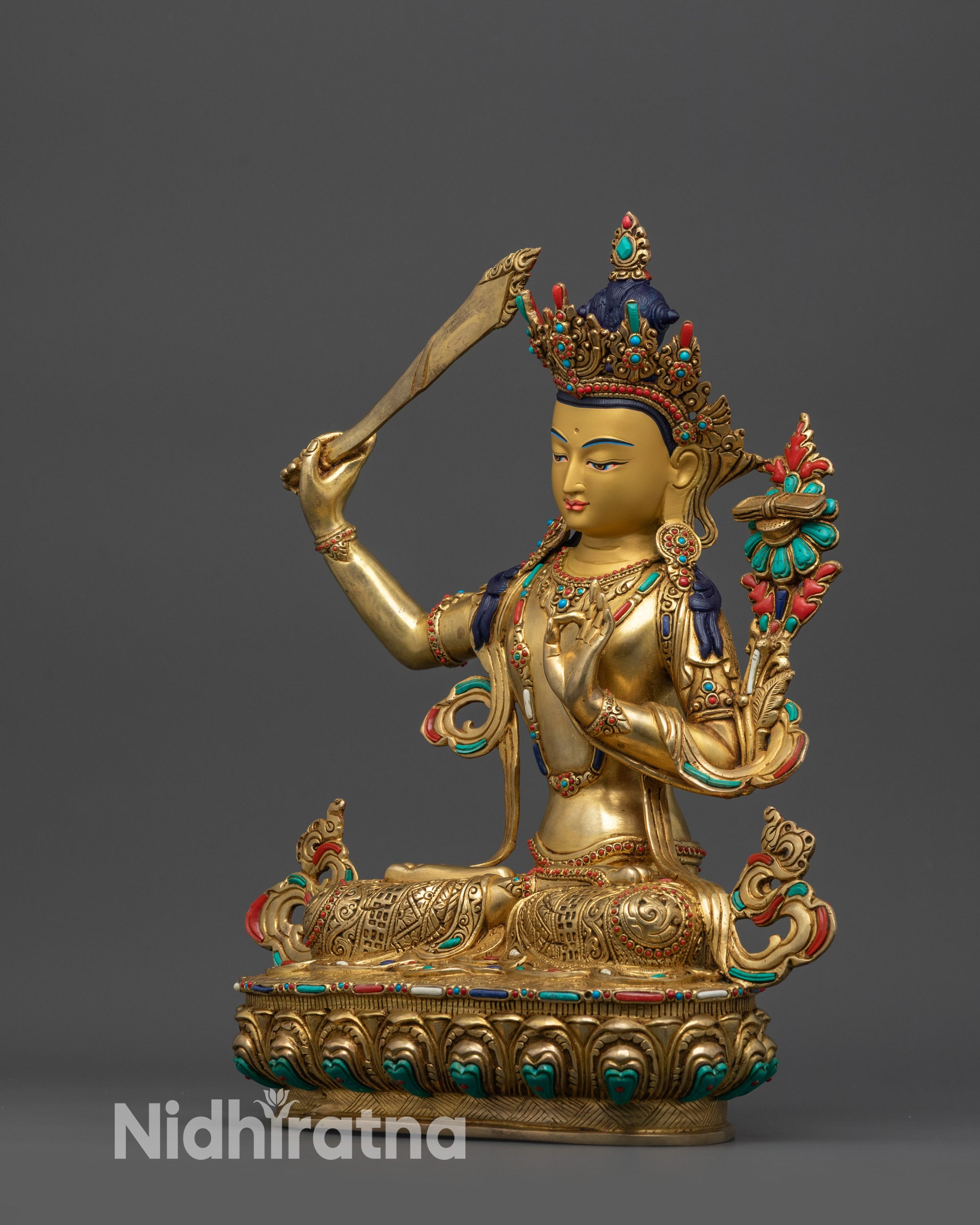 Side view of Tibetan Manjushri Sculpture with intricate swirling robes crafted by Newari artisans of Nepal.