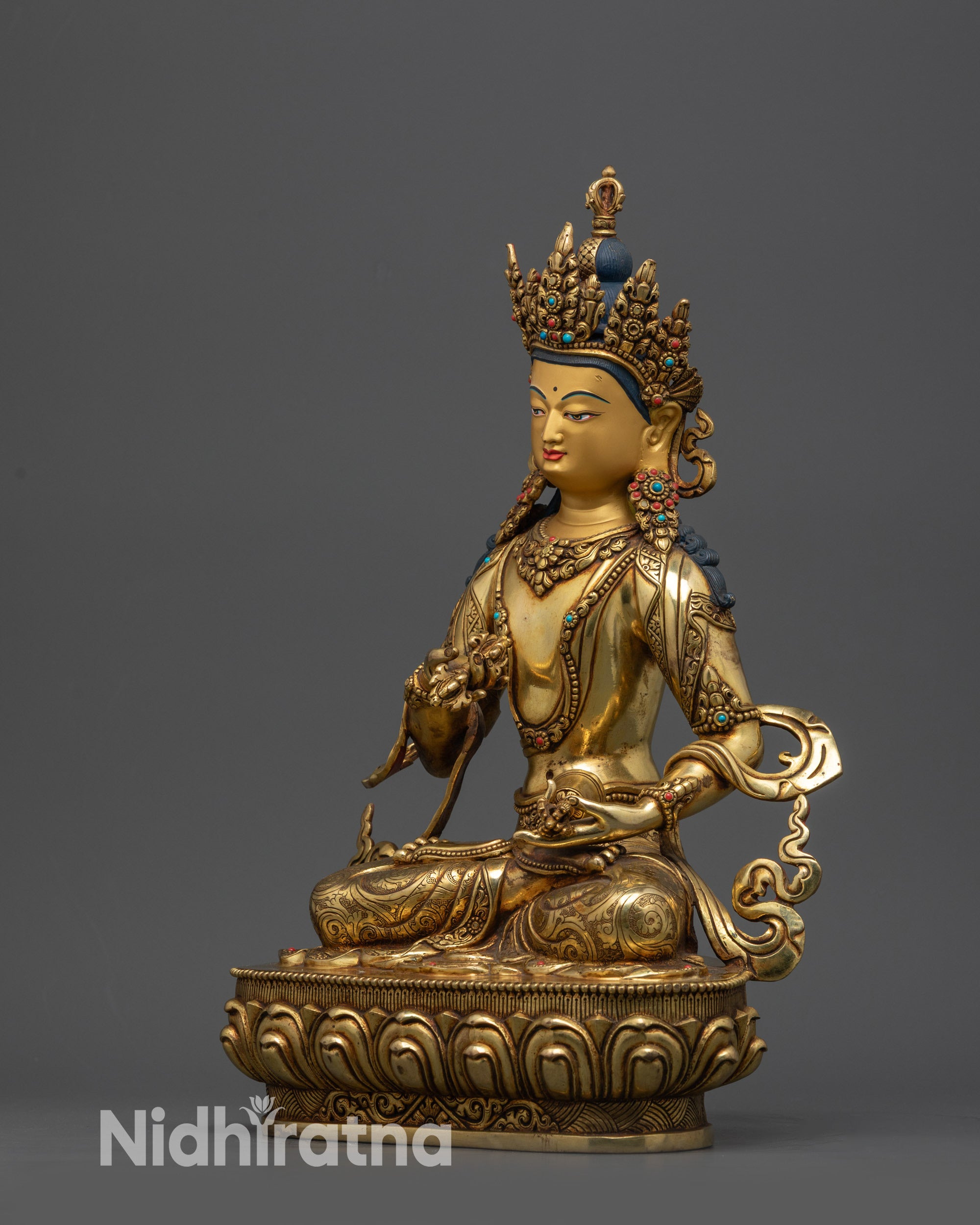 Side view of Tibetan Vajrasattva Statue highlighting flowing robe and intricately carved lower garment