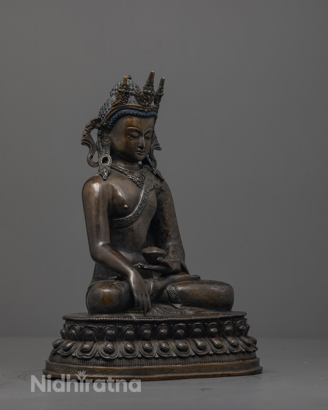Side view of a Traditional Nepalese artisan-crafted Shakyamuni Buddha statue