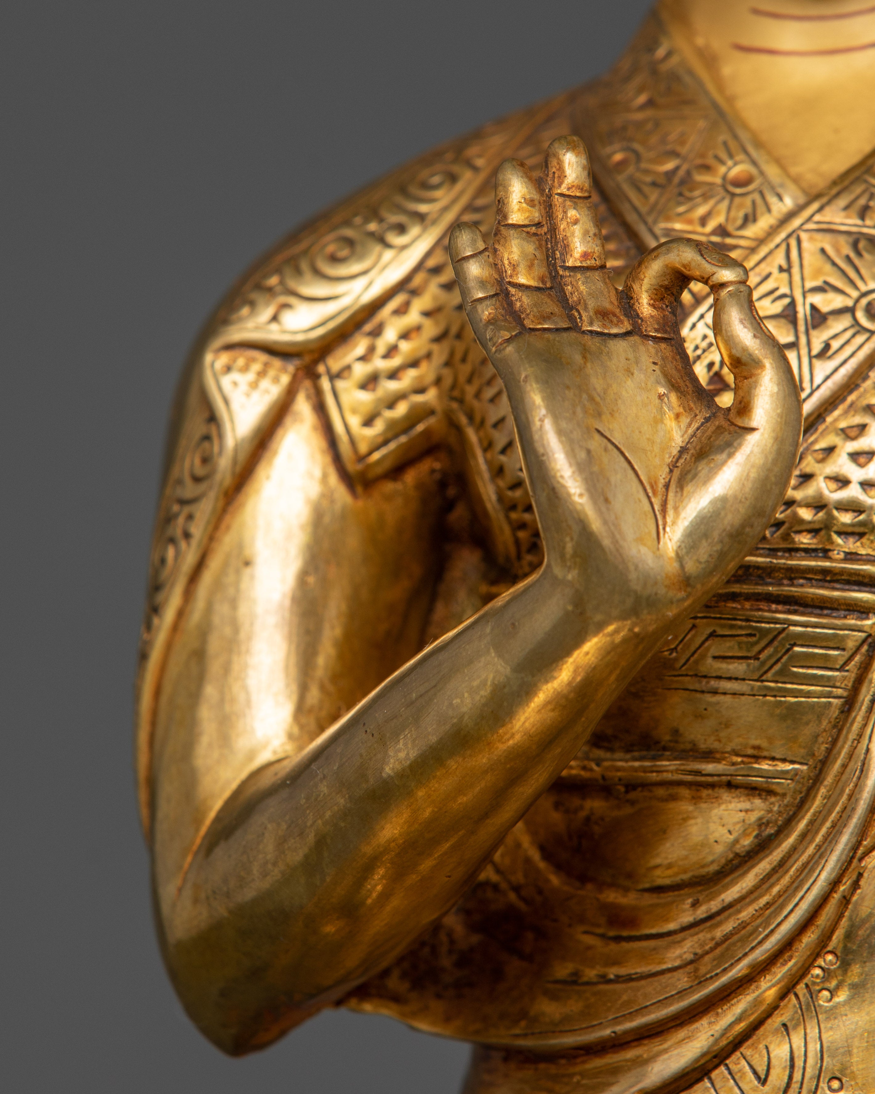 Side view of Tsongkhapa Triad statue highlighting meditative posture and delicate motifs