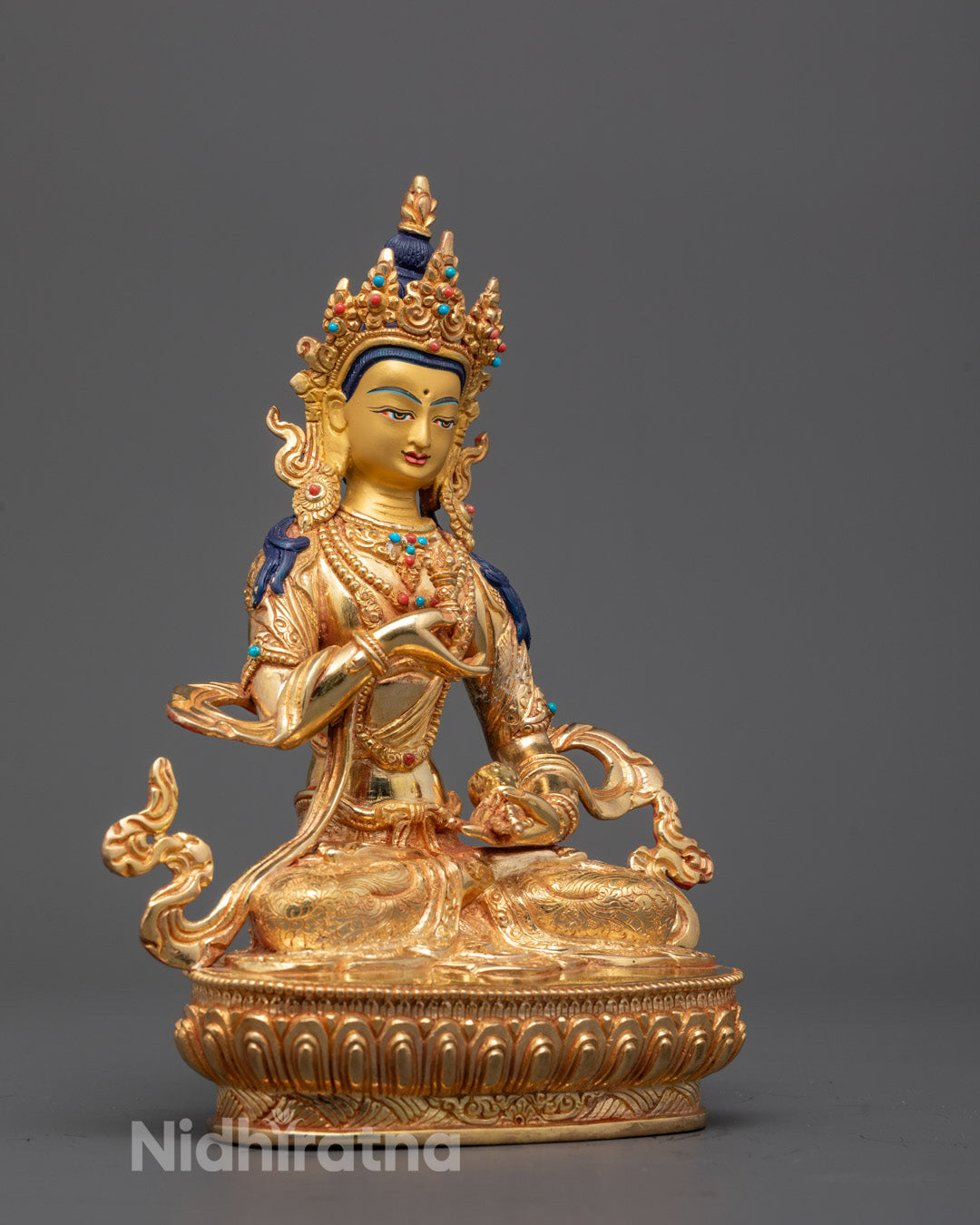 Side view of Vajrasattva Dorje Sempa sculpture showing kapala bowl and bell