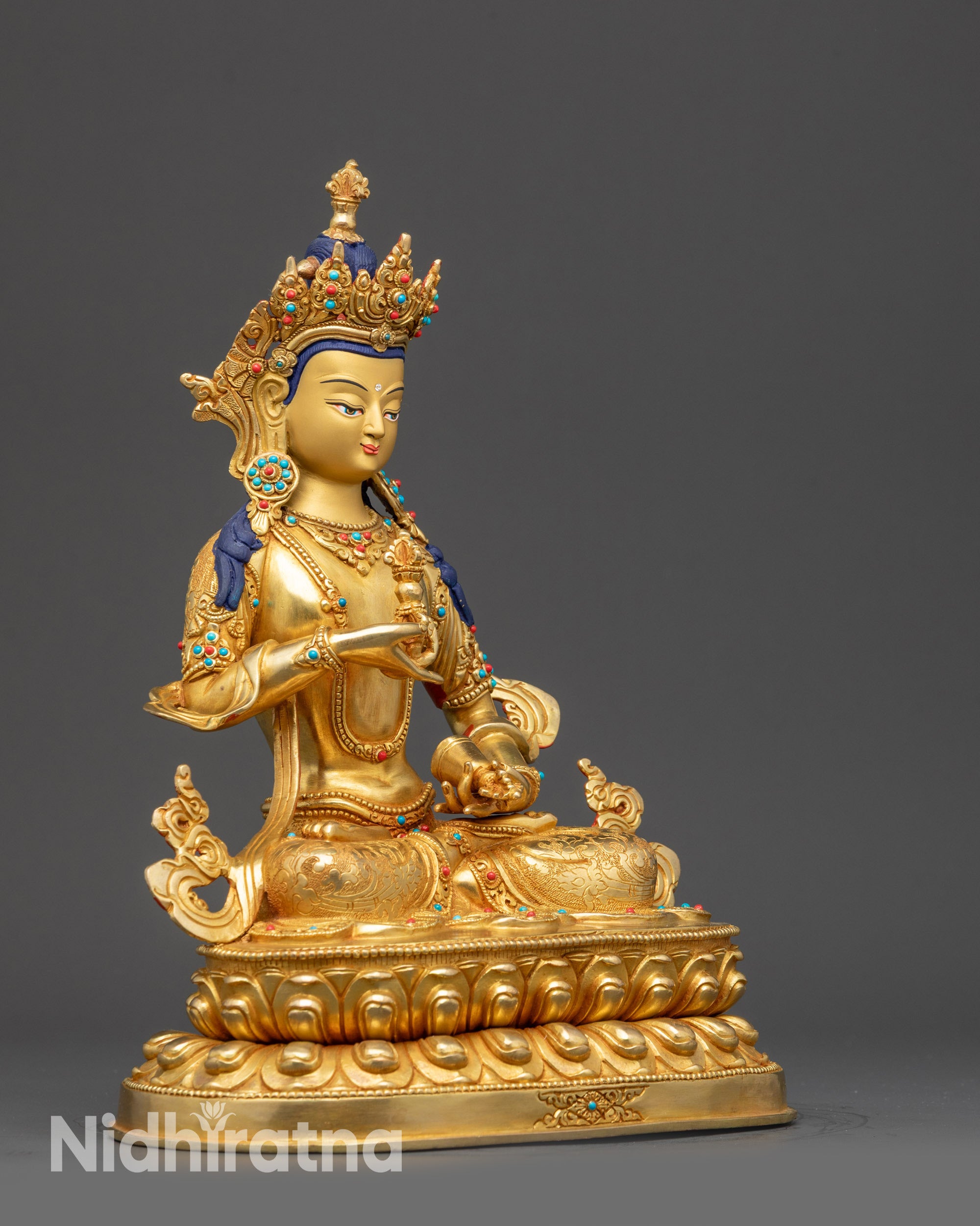 Side view of Vajrasattva Statue with flowing robes, jewelry, and five-jeweled crown