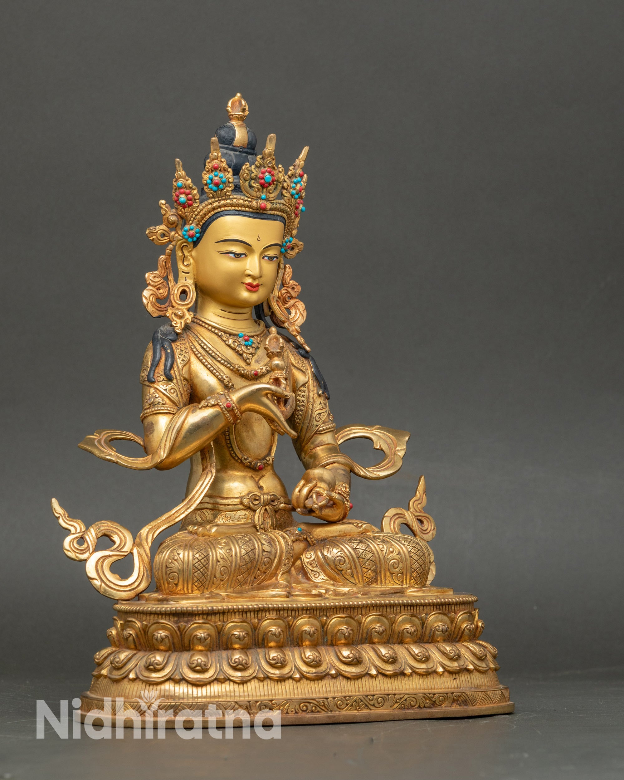 Side view of Vajrasattva altar statue showing intricate Newari craftsmanship and halo