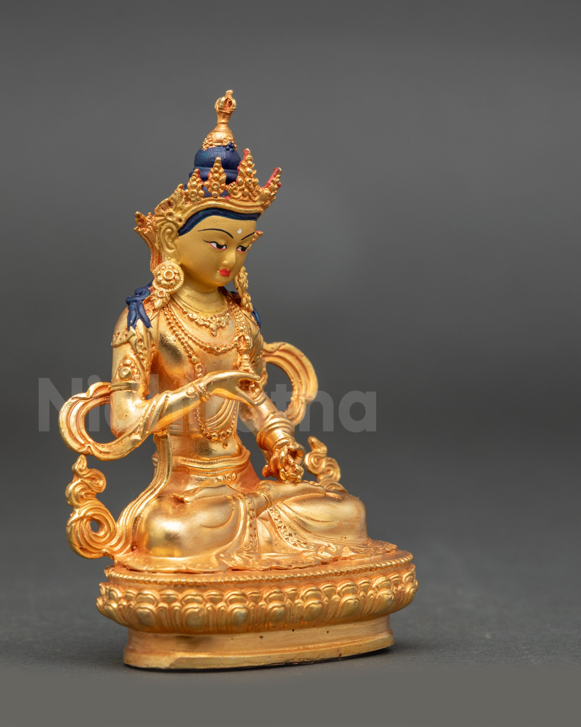 Side view of Vajrasattva statue showing lotus seat and method-wisdom symbolic hands