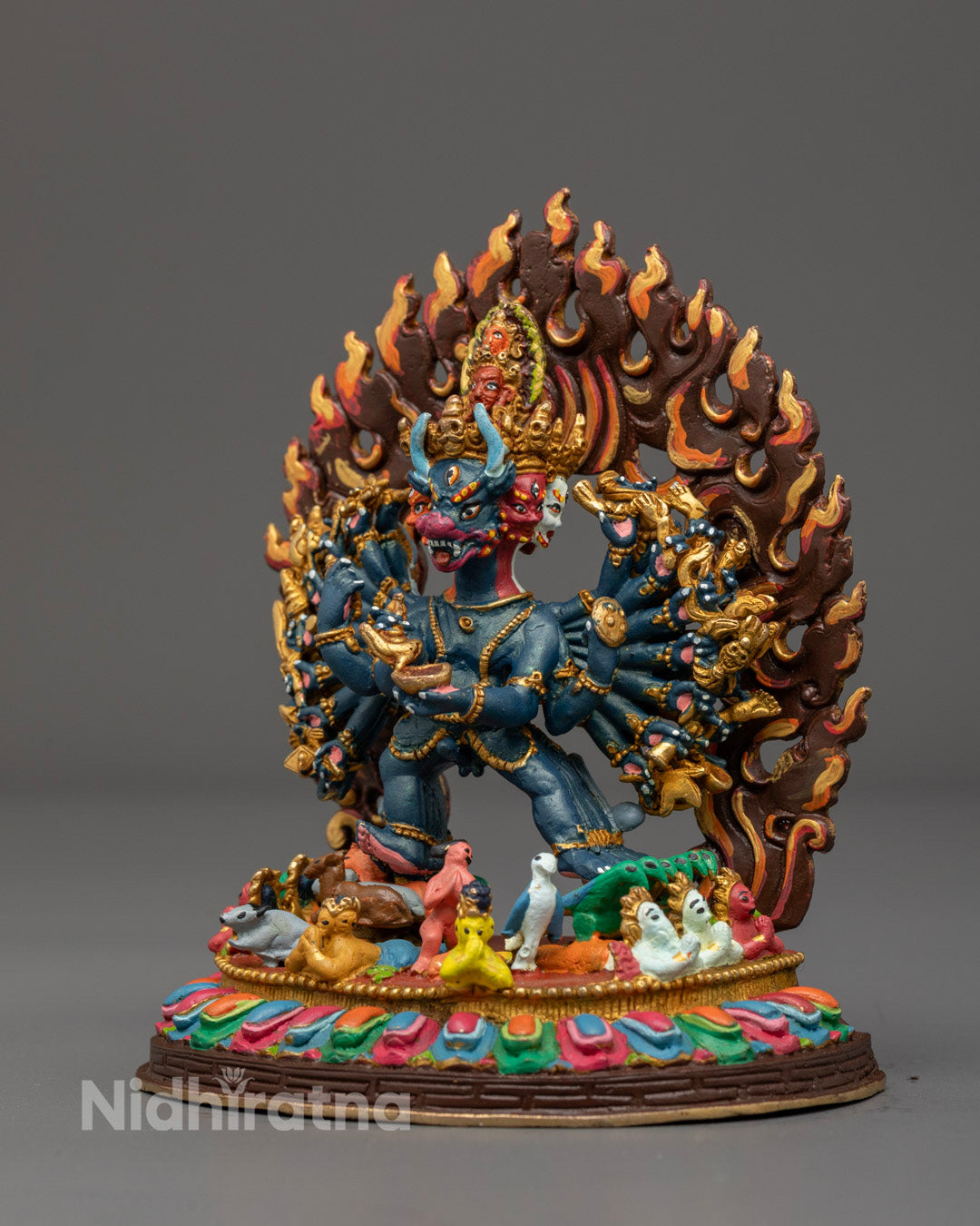 Yamantaka Statue displaying wrathful posture and symbolic weapons, made of oxidized copper with a hollow space for sacred relics