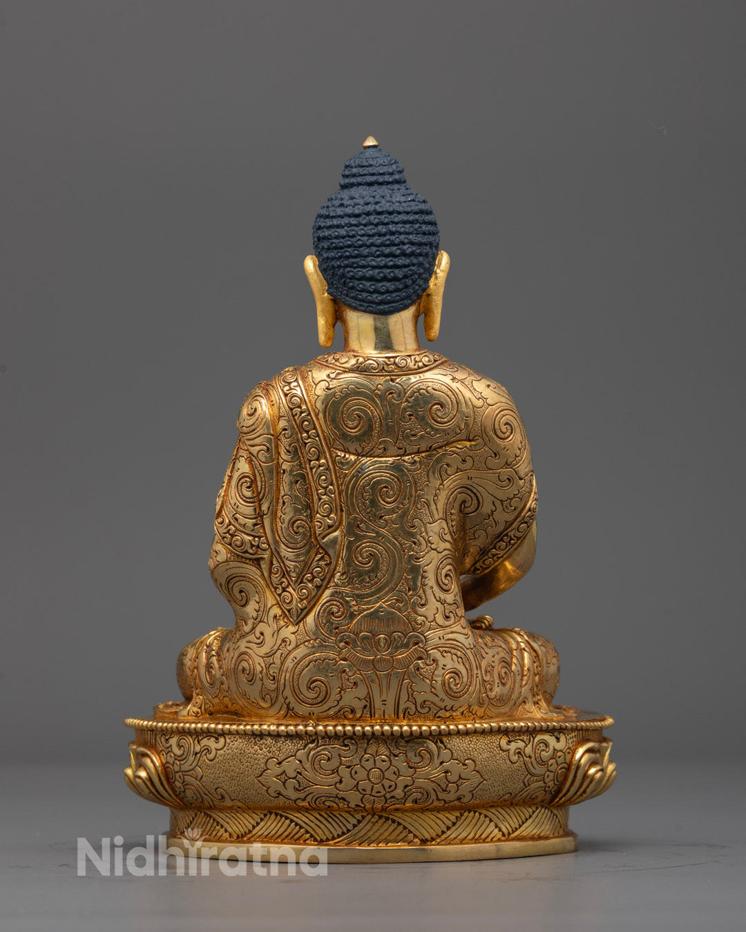 Side view of a radiant Amitabha Buddha sculpture adorned with a hollow consecration chamber
