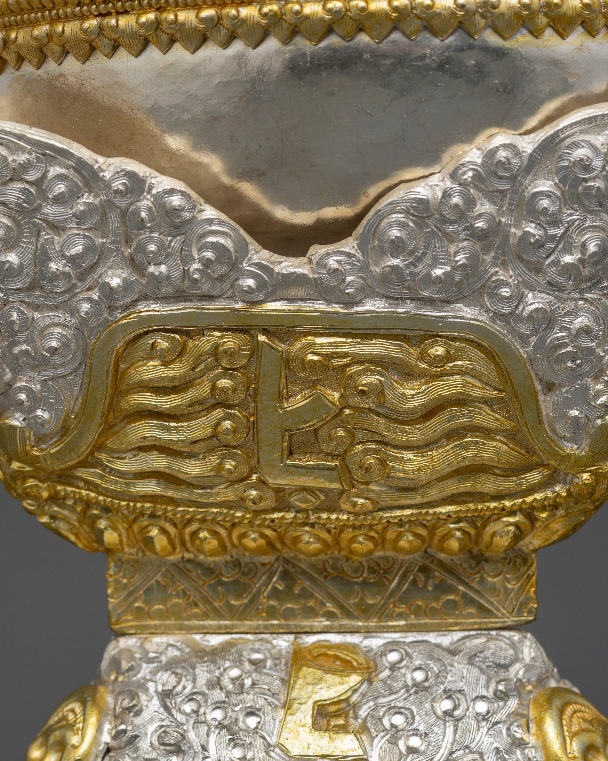 Side view of dual-section silver and gold-plated Tibetan ritual vessel Kapala