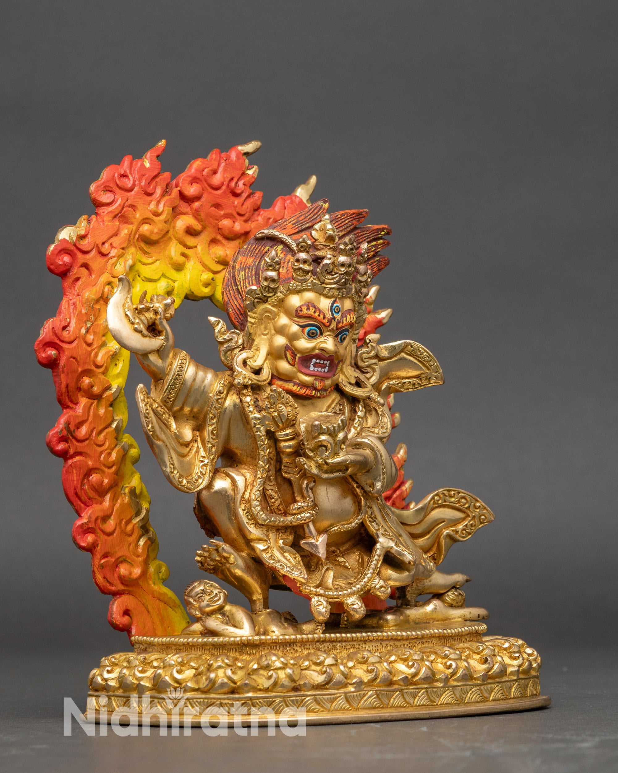 Side view of gold fire-gilded Mahakala Bernagchen altar statue showing ritual details
