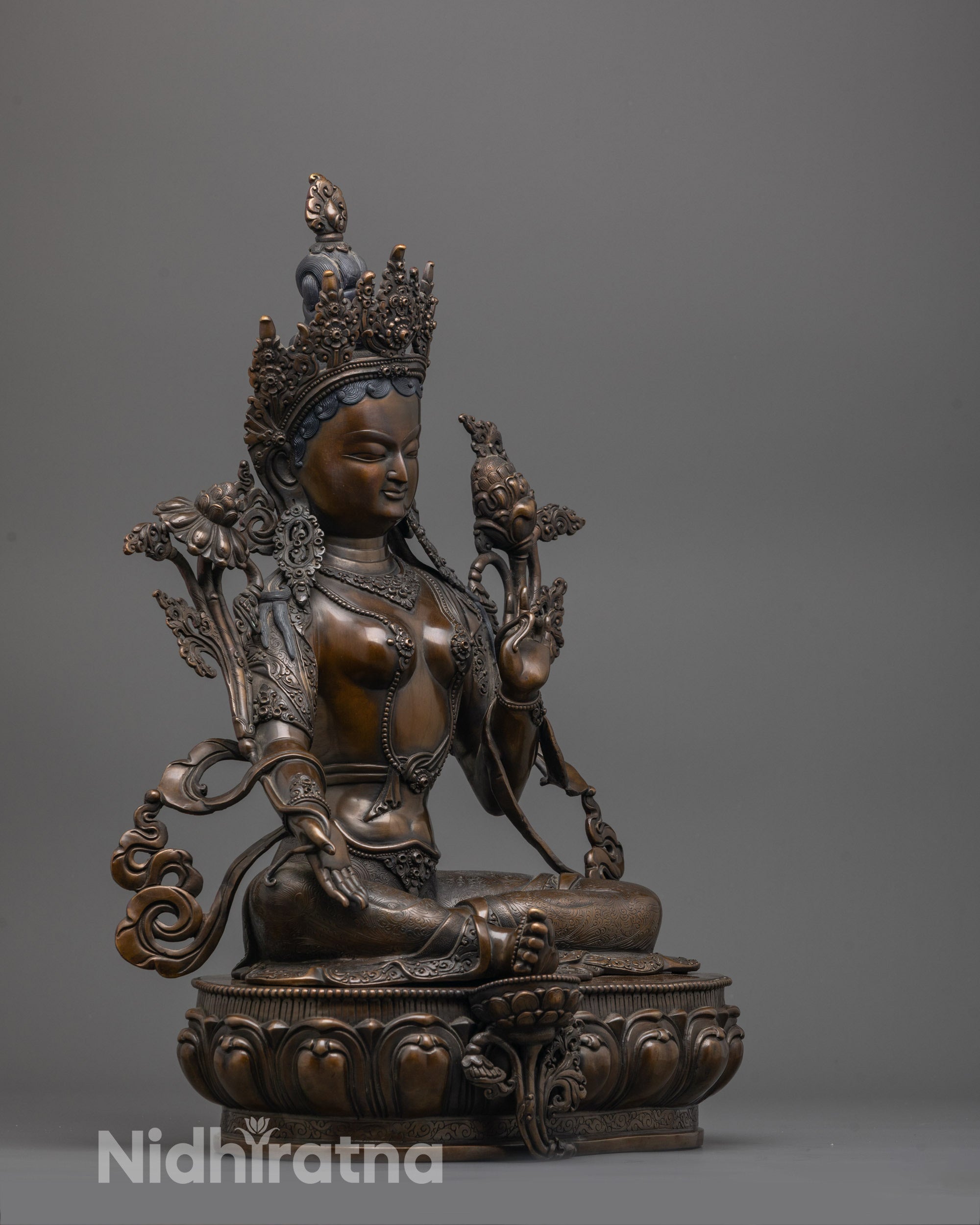 Side view of handcrafted Green Tara Statue with elegant posture and ornate lotus base