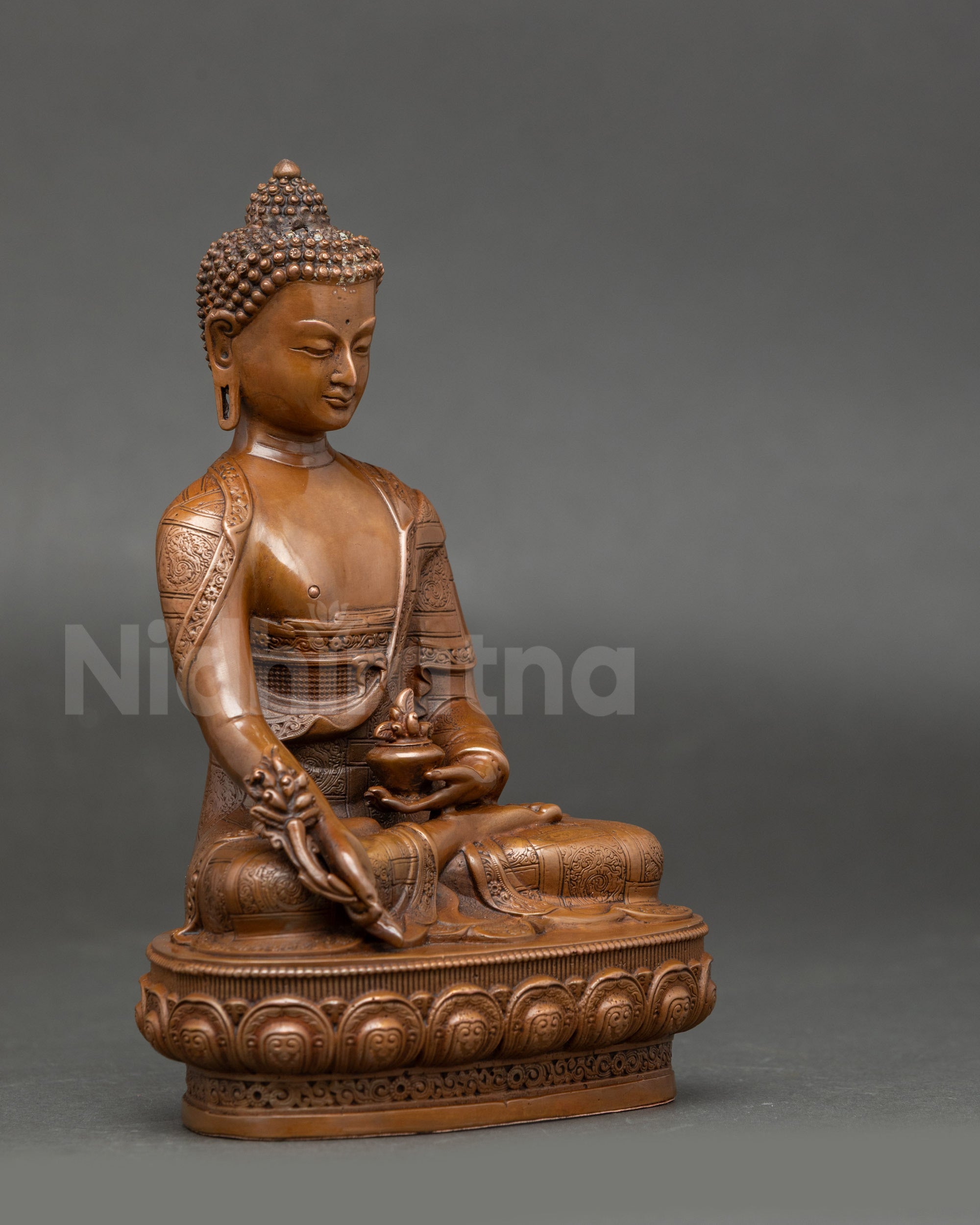 Side view of Medicine Buddha statue showing lotus seat, healing nectar jar, and Myrobalan fruit for spiritual restoration