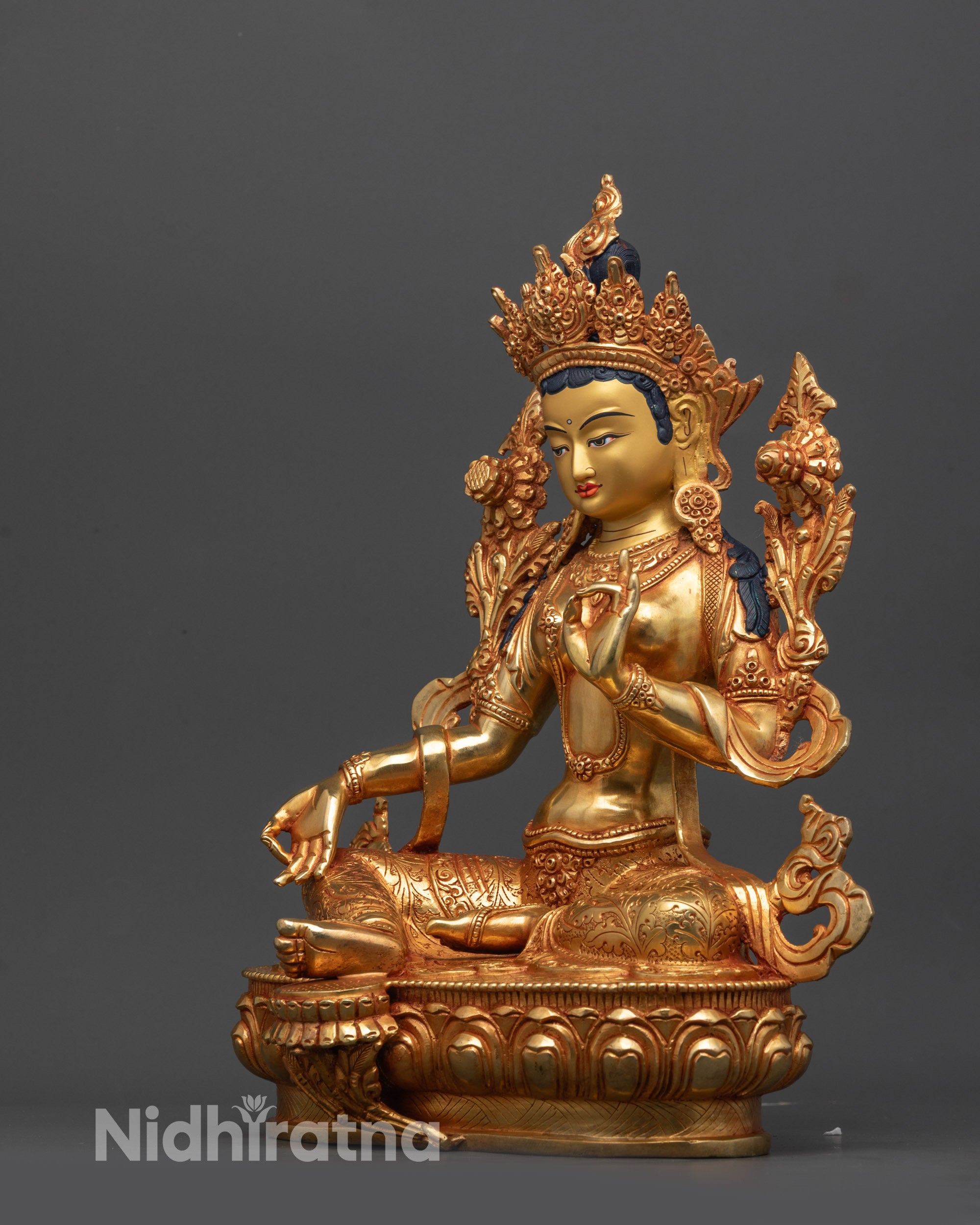 Side view of handcrafted Nepalese Mother Tara sculpture on lotus, spiritual décor