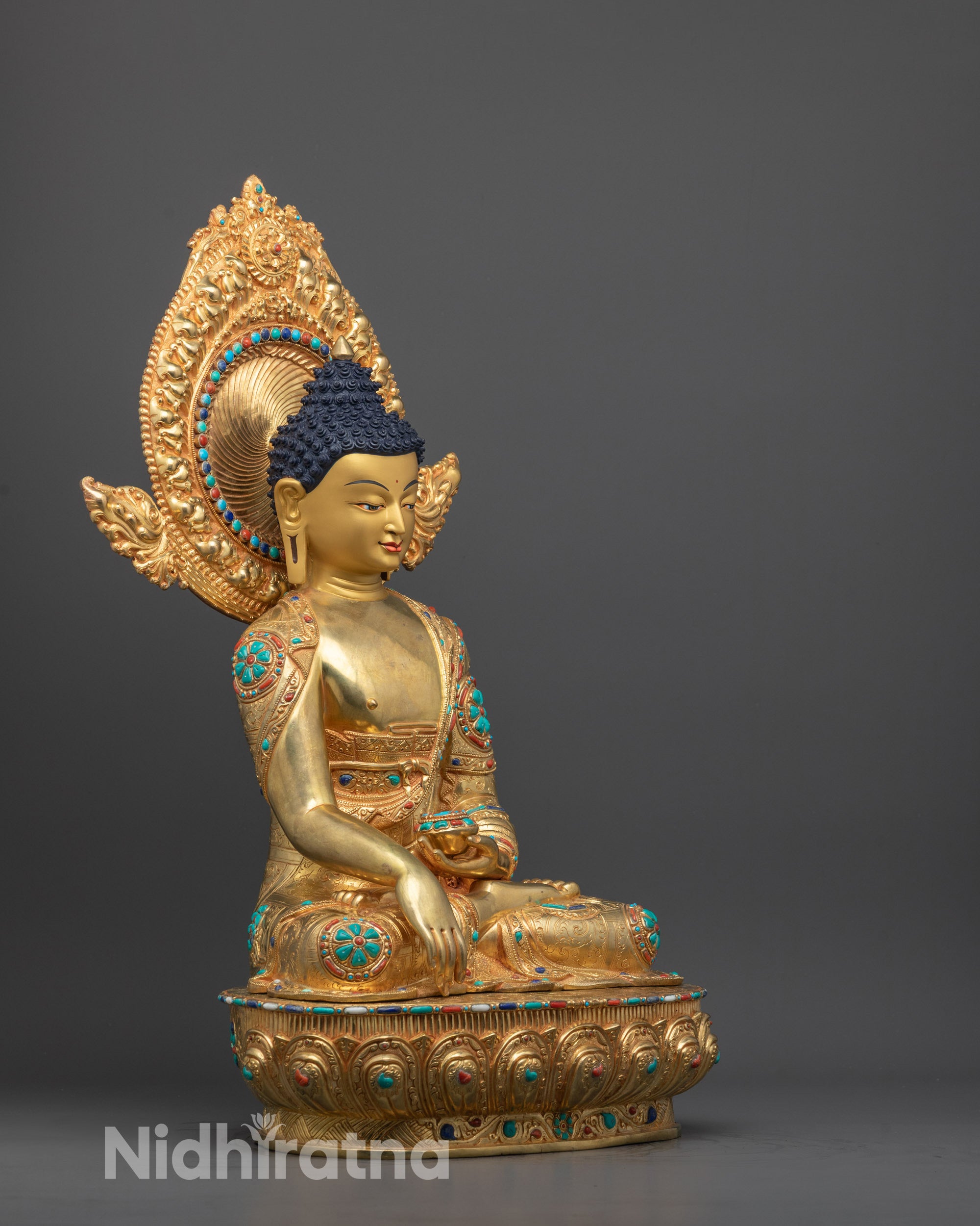 Side view of handcrafted Shakyamuni Buddha statue featuring lotus pedestal