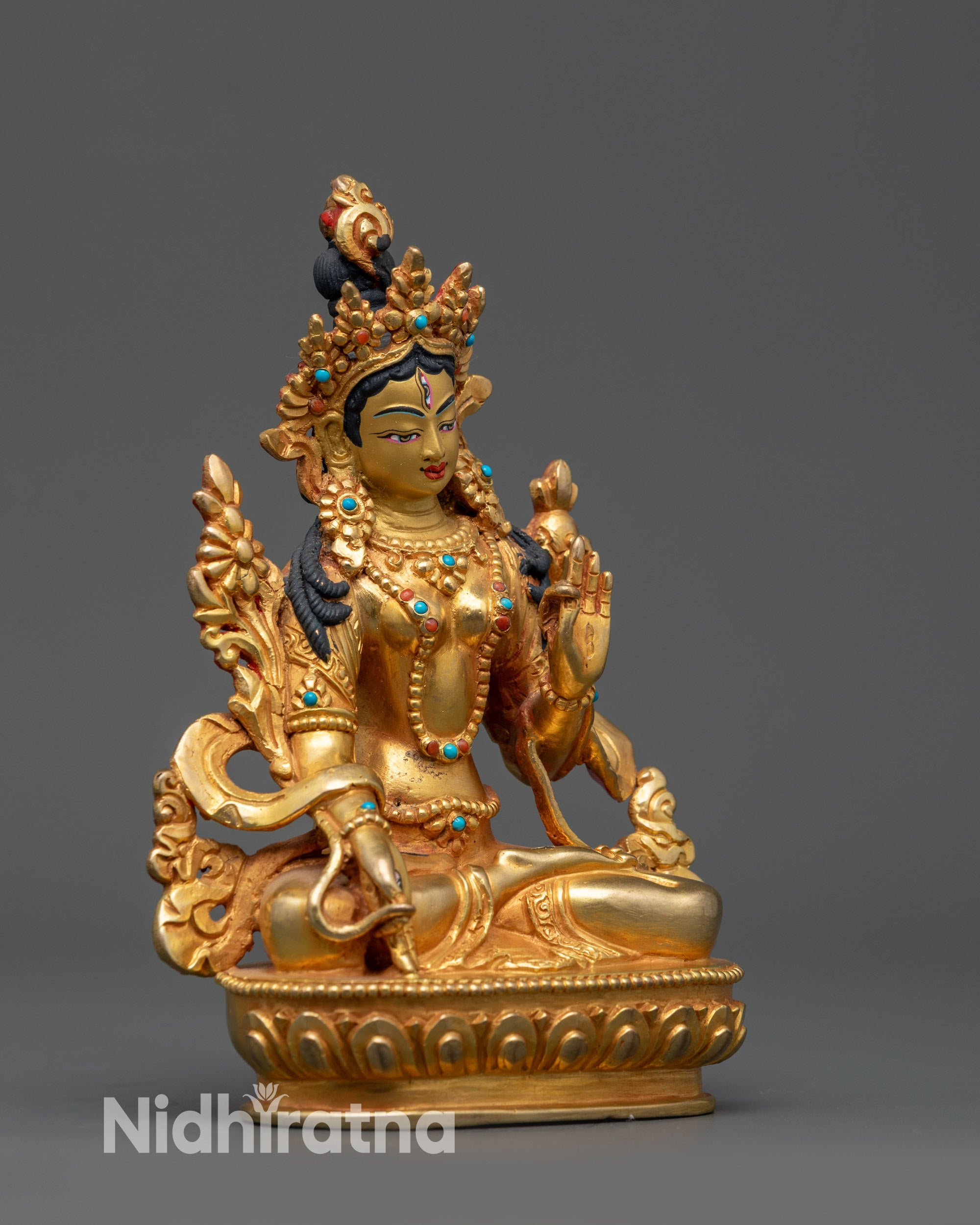 Side view of handcrafted Tibetan White Tara with detailed crown and flowing robes