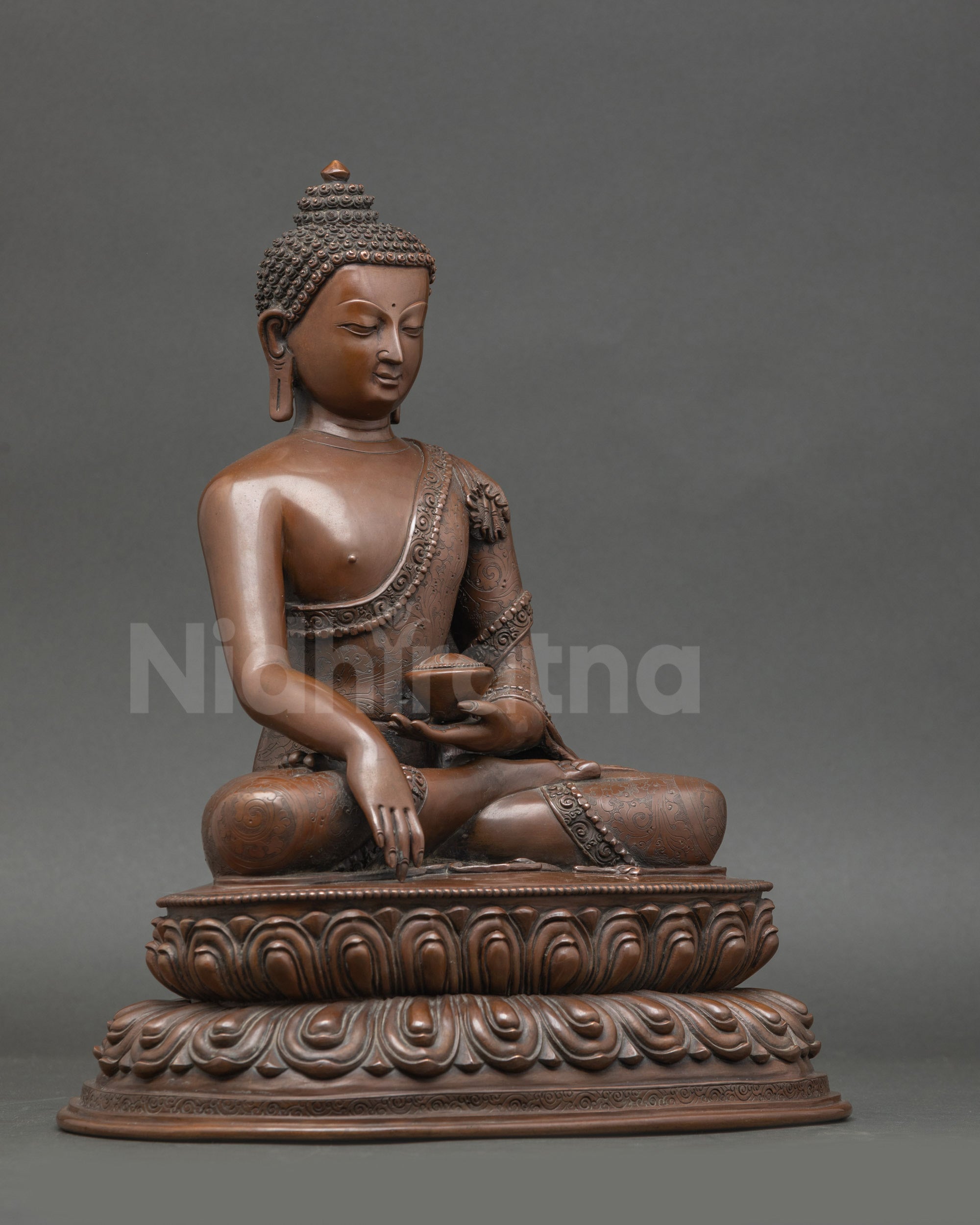 Side view of handmade Shakyamuni Buddha statue on double lotus throne
