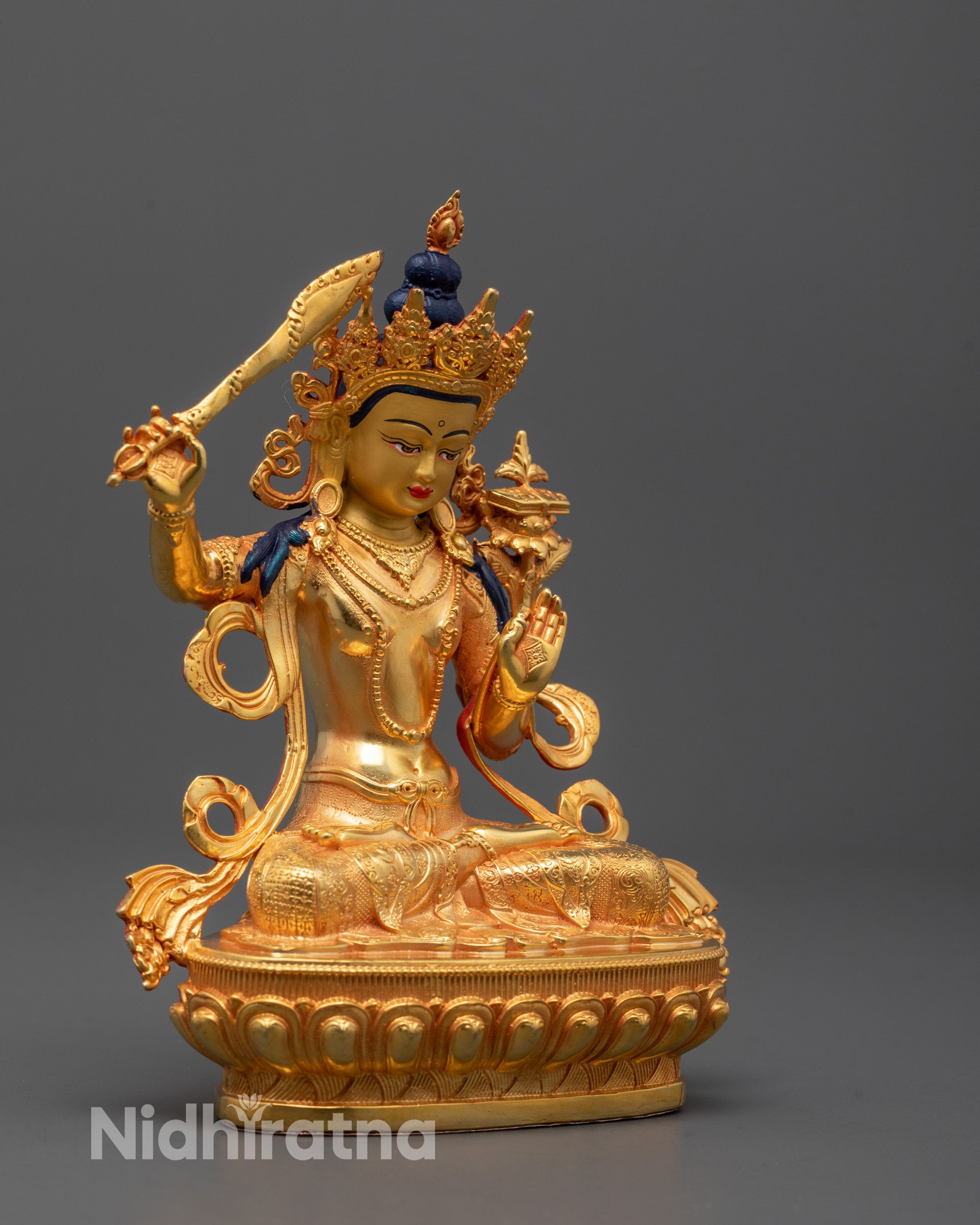 Side view of machine-made Manjushri statue holding sword symbolizing wisdom