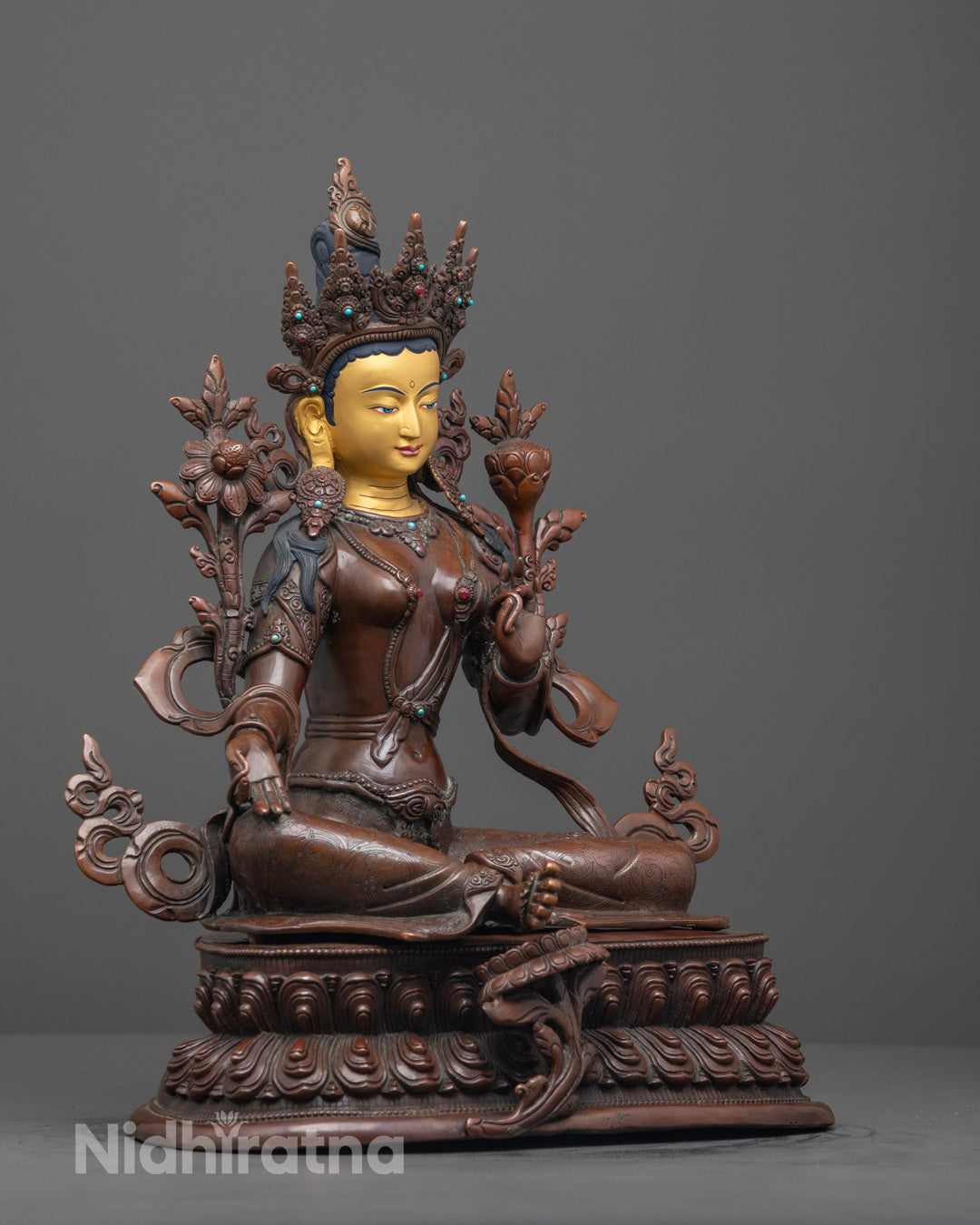Side view of oxidized Green Tara sculpture showing intricate craftsmanship