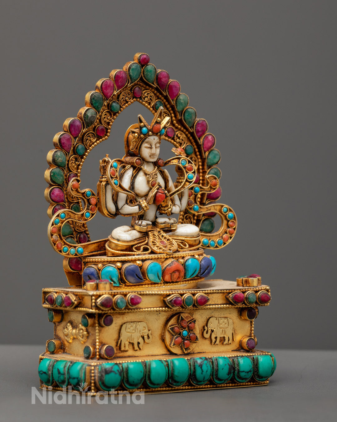 Stone Chenrezig sculpture highlighting the consecration chamber and spiritual symbolism.