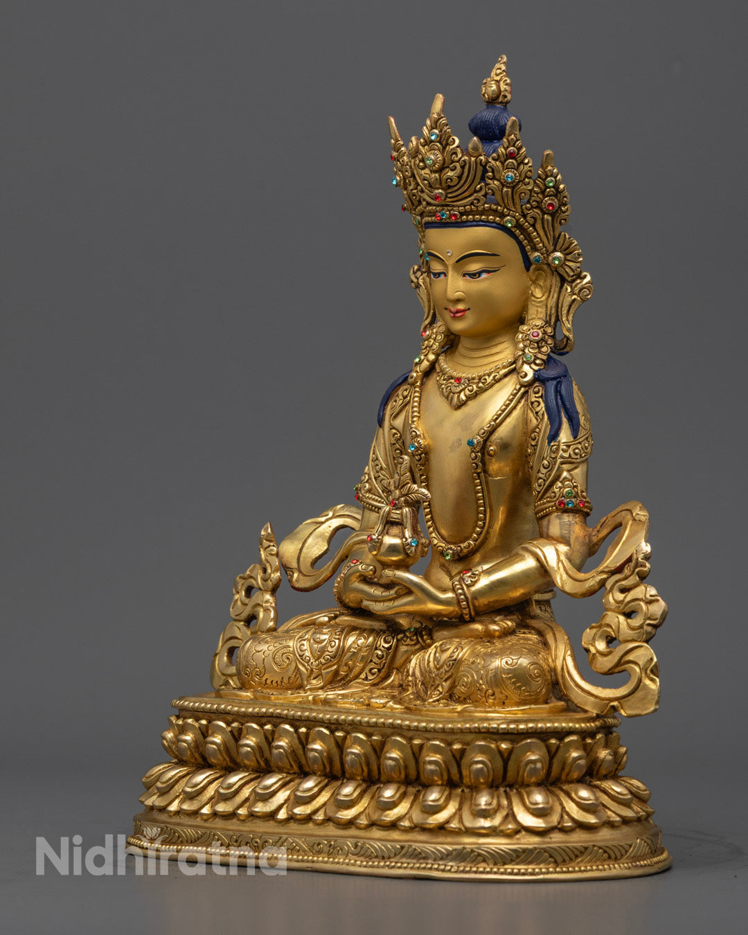 Amitayus Statue displaying detailed robe carvings, radiant gold shine, and sacred vase of amrita representing rejuvenation and healing energy