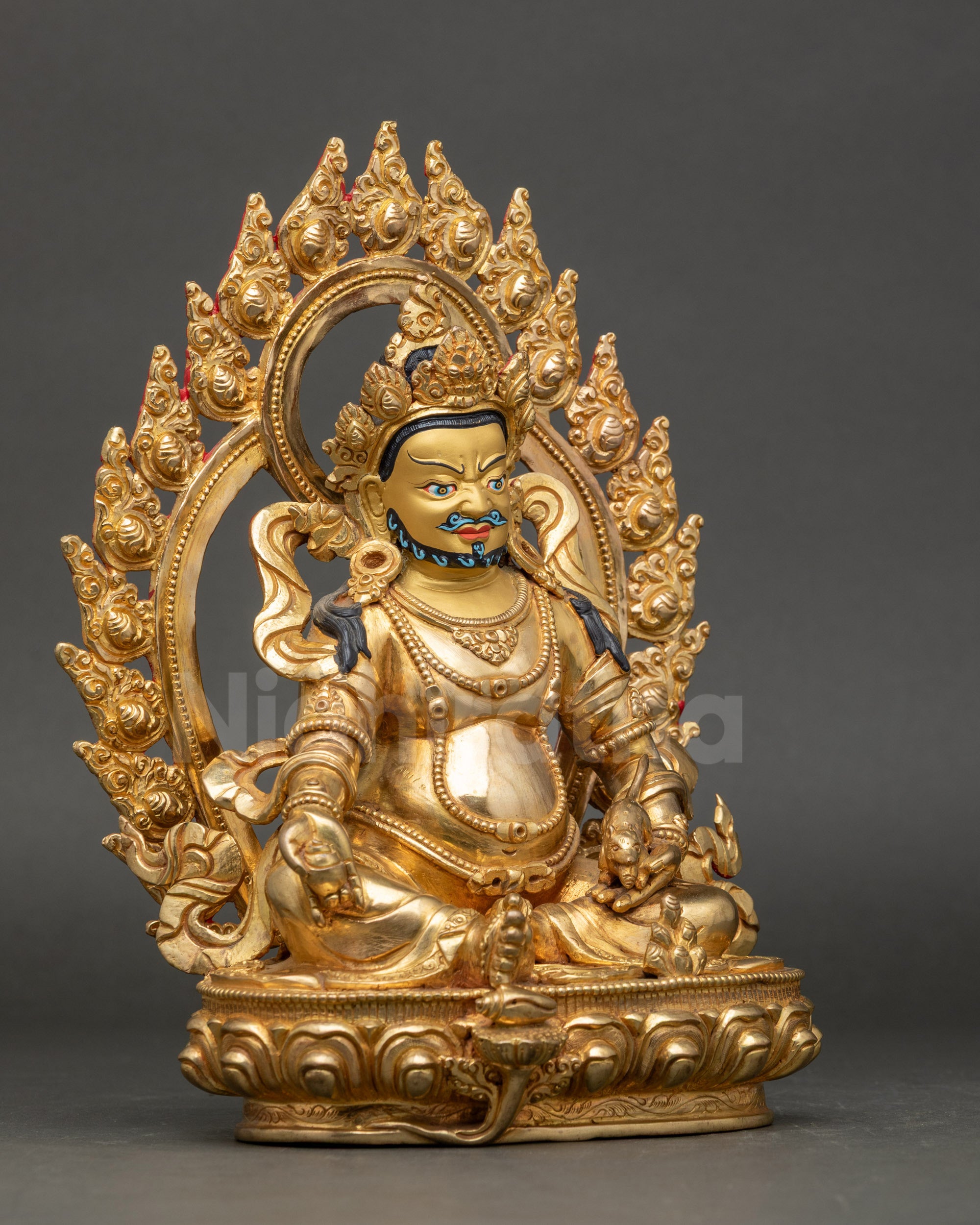 Side view pure gold Dzambhala statue holding jewel-spouting mongoose and citron fruit