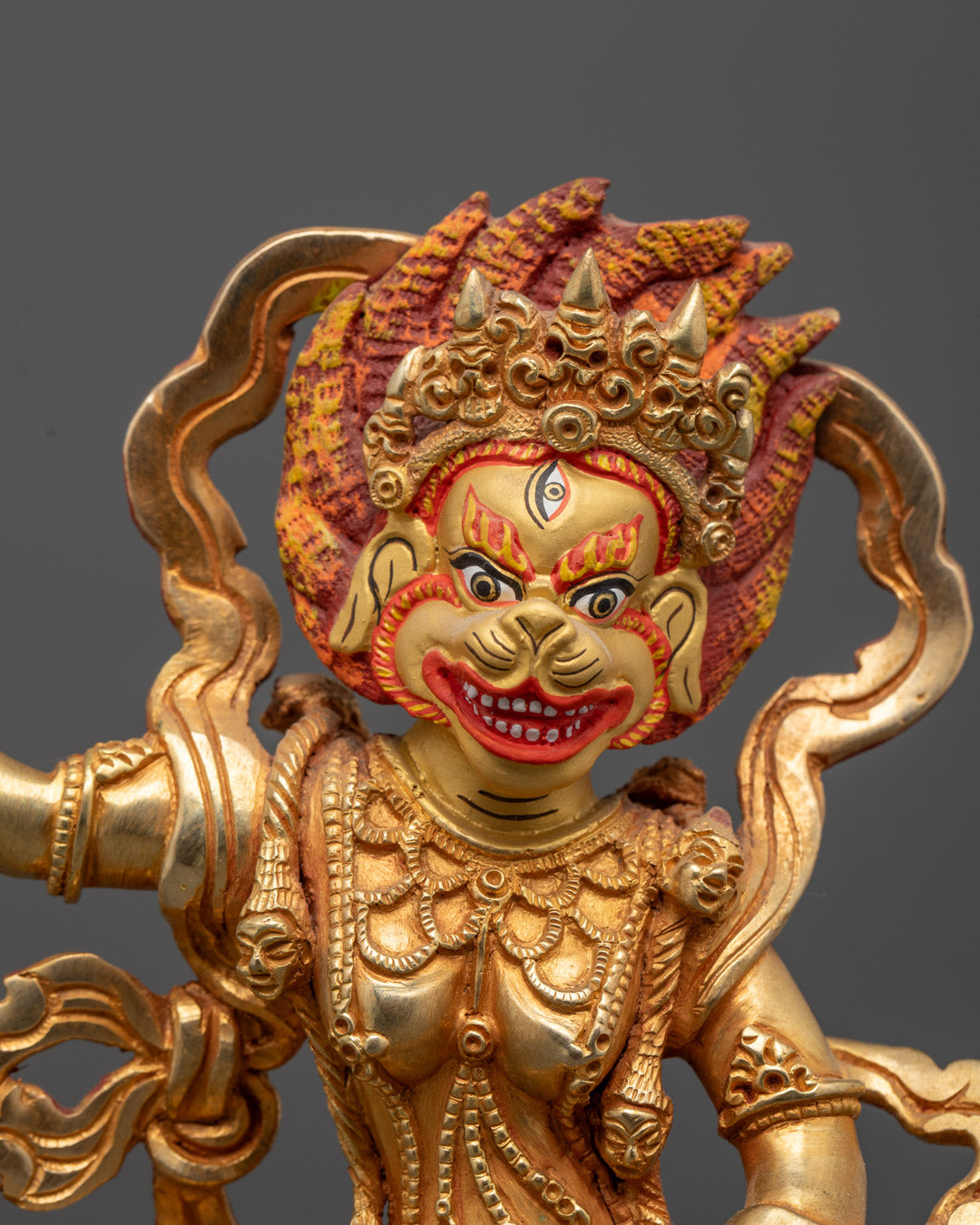 Close up of Simha Mukha statue, showing intricate details and 24K gold-plated face