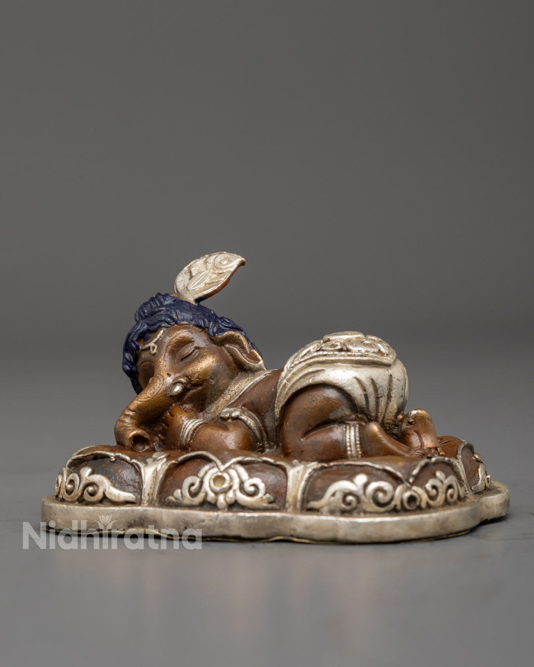 Sleeping Bal Ganapati idol placed on home altar with spiritual decor – symbol of peace, purity, and protection